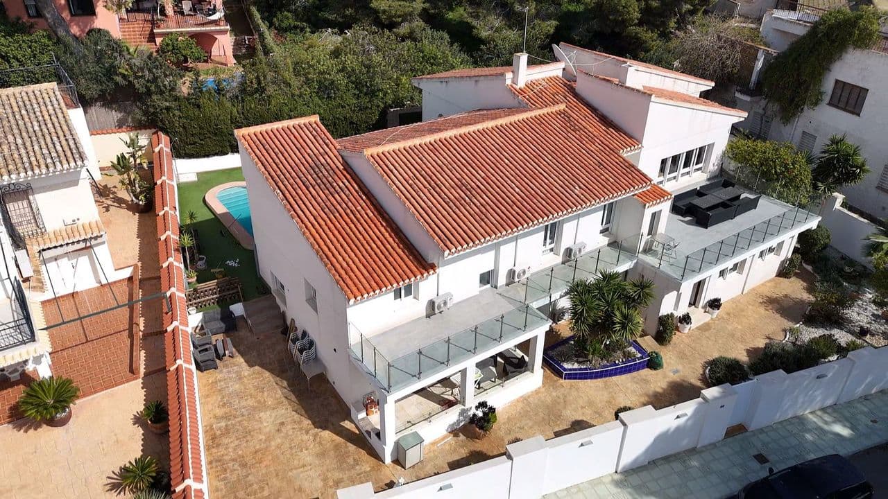 We are proud to introduce this outstanding coastal residence, ideally located in a peaceful cul-de-sac within one of the most sought-after neighbourhoods in the area — only a short stroll from the renowned La Glea Beach and the prestigious WOW Beach Club by Las Colinas.This substantial home offers eight spacious bedrooms and five bathrooms, in addition to a self-contained two-bedroom guest apartment with its own private entrance — perfect for extended family, visitors, or as a rental opportunity.On the main level, you are welcomed by a bright and airy open-plan living and dining space, finished with elegant marble floors. The fully fitted kitchen, complete with a breakfast bar, leads directly onto a covered terrace featuring a built-in barbecue area — ideal for outdoor dining and entertaining throughout the year.The upper floor boasts a generous second lounge filled with natural light from large windows, creating a relaxing space that opens onto a spacious terrace where you can enjoy the sea air. This level also includes the master bedroom with its own en-suite bathroom and walk-in dressing area, along with further well-proportioned bedrooms and bathrooms for family and guests.The separate guest accommodation comprises a comfortable living and dining area, kitchen, two bedrooms, a shower room, and its own private terrace — offering excellent flexibility for guests, older children, or rental use.Further features of the property include oil central heating, air conditioning throughout, plentiful storage space, private off-road parking, and a large swimming pool surrounded by sunbathing areas. The property is being sold fully furnished and equipped, allowing immediate enjoyment.With a proven and significant holiday rental return, this is not only a fantastic lifestyle purchase but also a superb investment opportunity