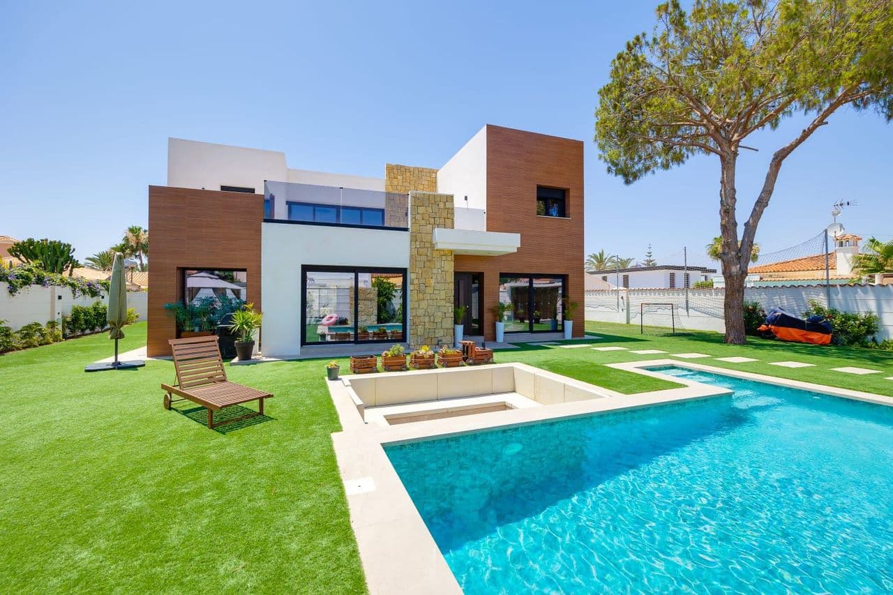 ✨ Ultra-Luxury Contemporary Villa | Torreta Florida, TorreviejaAn exceptional detached villa in the prestigious and highly sought-after area of Torreta Florida, perfectly positioned near the famous pink salt lakes and just a short drive from Torrevieja’s finest sandy beaches.Built in 2024 on an impressive 850 m² private plot, this striking contemporary home offers 250 m² of beautifully designed living space, combining architectural elegance with cutting-edge technology and premium finishes throughout.*Interior HighlightsSet across two levels, the villa features soaring high ceilings and expansive windows, flooding the home with natural light and creating a remarkable sense of space and openness.5 spacious bedrooms, designed for comfort and privacy4 bathrooms in total, including luxury bathrooms with self-cleaning whirlpool tubsTwo generous living rooms, offering flexible entertaining and relaxation spacesDedicated office, ideal for remote working or a private studyThe villa stands out for its clean architectural lines, refined materials, and meticulous attention to detail, delivering a perfect balance of contemporary style and everyday comfort.*Designer Kitchen & FinishesThe heart of the home is the bespoke Schmidt kitchen, valued at €25,000, featuring:High-end integrated appliancesInduction hob with integrated extractorPremium ceramic finishesMatte black aluminium carpentry throughout the propertyEvery element has been carefully selected to enhance both aesthetics and functionality.*Smart Home TechnologyThis villa is fully equipped for modern living, including: Intelligent lighting system controlled via mobile app, Ethernet connections in all rooms, dining area, and kitchen, LG washer & dryer with WiFi connectivity, Centralised air conditioning and Hot water system via electric heater*Outdoor Living – A Private Mediterranean RetreatThe exterior is nothing short of spectacular, designed to enjoy the Costa Blanca lifestyle year-round: Saltwater swimming pool with waterfall feature, Private mini football/soccer pitch, Sunken conversation pit, perfect for evening gatherings, Multiple outdoor dining and lounge areas, Fully equipped barbecue area, Manicured gardens and sunny terraces.This outdoor space offers complete privacy and is ideal for entertaining, relaxing, and enjoying long Mediterranean days with family and friends.🌞 A Rare Opportunity - This turn-key luxury villa is a rare find in Torreta Florida — ideal as a permanent residence, luxury holiday home, or high-end investment property.Early viewing is highly recommended to truly appreciate the quality, space, and lifestyle this exceptional villa offers.