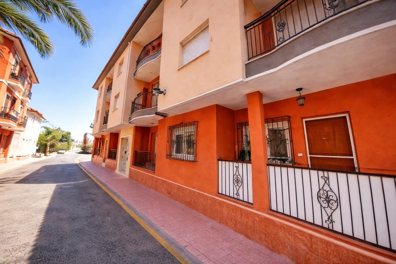 Ideally located in the heart of Los Alcázares, this bright and spacious 2-bedroom, 1-bathroom apartment offers the perfect blend of comfort, convenience, and coastal living — just a 5-minute walk to the beach and all local amenities.Situated in a well-maintained building with a lift, the property also benefits from a private parking space in the underground garage and a separate storage room — invaluable extras so close to the sea.As you enter the apartment, you are welcomed by a central hallway. To the right is a generous, separate kitchen with ample workspace and storage, along with a practical utility room housing the washing machine and additional space for household needs.Leading on from the kitchen, you step into a spacious and light-filled living room — the heart of the home. From here, doors open onto a private balcony, providing the perfect spot to enjoy your morning coffee or relax in the evening Mediterranean air.The property offers two good-sized bedrooms, both with fitted wardrobes, providing excellent storage. A well-appointed family bathroom serves the apartment.With its unbeatable location near the beach, shops, restaurants, and services, plus the added convenience of parking, storage, and lift access, this apartment is ideal as a holiday home, rental investment, or permanent residence on the beautiful Costa Cálida.
