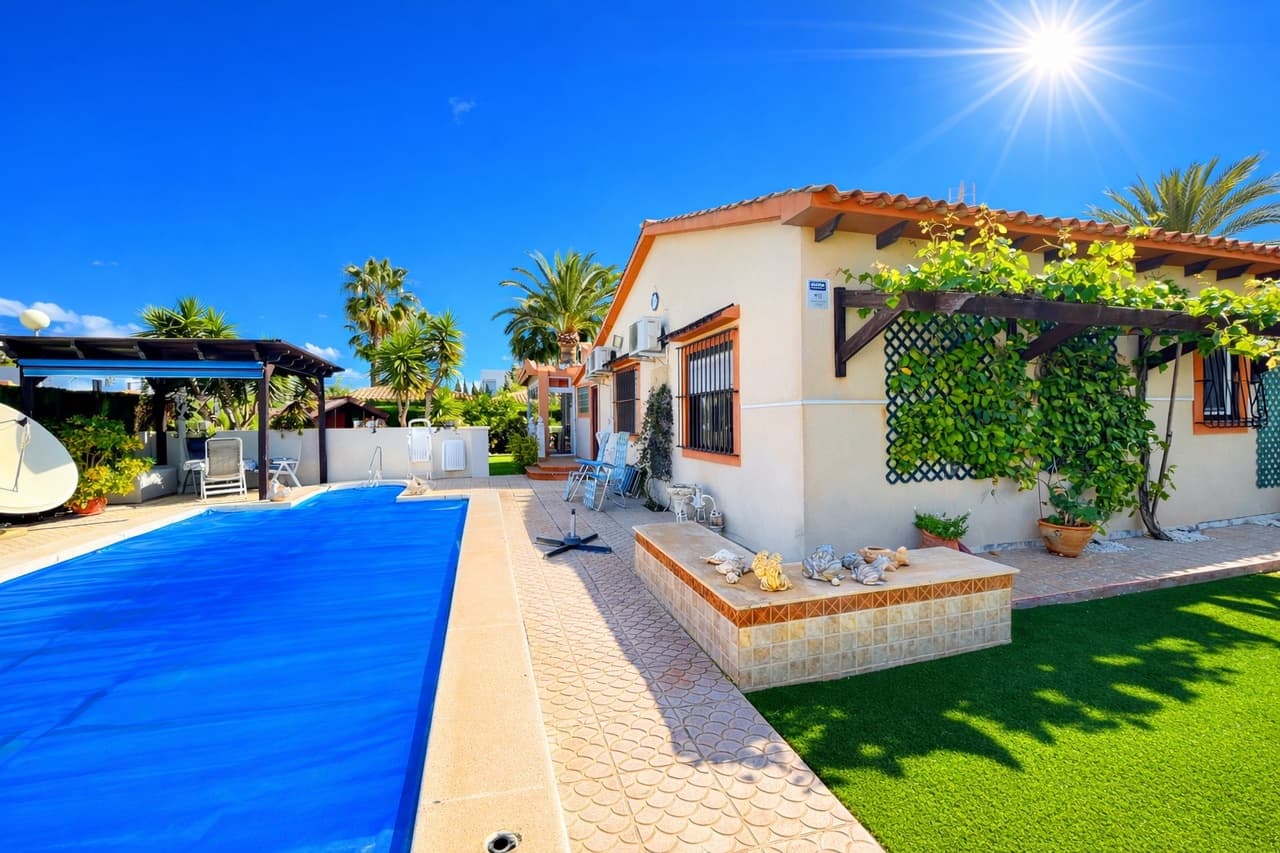 Set on a generous 800m² plot in the highly sought-after beachside area of Cabo Roig, this beautifully maintained 3-bedroom, 2-bathroom villa offers the perfect blend of space, privacy, and authentic Spanish charm — all on one convenient level.Immaculate throughout, the home exudes warmth and character from the moment you step inside. Traditional Spanish features blend effortlessly with bright, spacious interiors, creating a welcoming atmosphere that feels both elegant and comfortable. Every room has been lovingly cared for, making this a truly move-in-ready property.The villa boasts three generous bedrooms and two well-appointed bathrooms, offering comfortable accommodation for family and guests alike. The spacious living areas provide plenty of room for relaxing or entertaining, while large windows allow natural light to flood the home, enhancing its airy feel.Outside, the expansive 800m² plot offers exceptional privacy and beautifully maintained grounds. The private swimming pool is the centrepiece of the outdoor space — perfect for cooling off in the summer months or enjoying long days in the Mediterranean sunshine. There is ample terrace space for dining, lounging, and entertaining, surrounded by mature planting that enhances the villa’s charm and seclusion.A private garage adds further convenience and secure parking, completing this superb offering.Located just a short stroll from the beach in Cabo Roig, this immaculate, single-level villa is a rare opportunity to own a spacious, character-filled home in one of the Costa Blanca’s most desirable coastal locations.