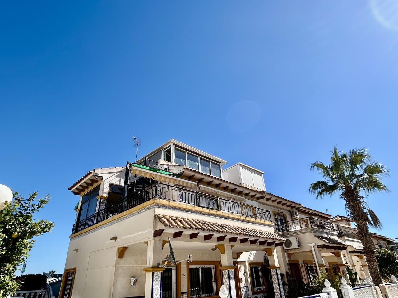 This beautifully presented top-floor apartment in sought-after Punta Prima offers the perfect combination of comfort, outdoor space, and a peaceful setting, making it ideal as a holiday home, rental investment, or permanent residence. Set within a quiet, well-maintained community, residents can enjoy access to a stunning large communal swimming pool, perfect for cooling off on warm summer days or relaxing with family and friends in a tranquil environment. On the ground level, the property benefits from its own private garden and utility area, providing practical storage and a welcoming outdoor space to unwind or entertain.Upstairs, the main living area is bright and inviting, featuring a closed-in conservatory that creates a versatile additional living or dining space for year-round use. From here, you step out onto the south-facing sunny terrace, ideal for enjoying the sun throughout the day and making the most of the Mediterranean climate. The apartment offers two well-proportioned bedrooms and a bathroom, while the enclosed solarium has been cleverly converted into an extra room, perfect as a guest bedroom, home office, or relaxation space.Ideally located, the property is within walking distance of all amenities, including shops, bars, and restaurants, and just a few minutes’ drive from the beach, allowing you to enjoy coastal living at its best.