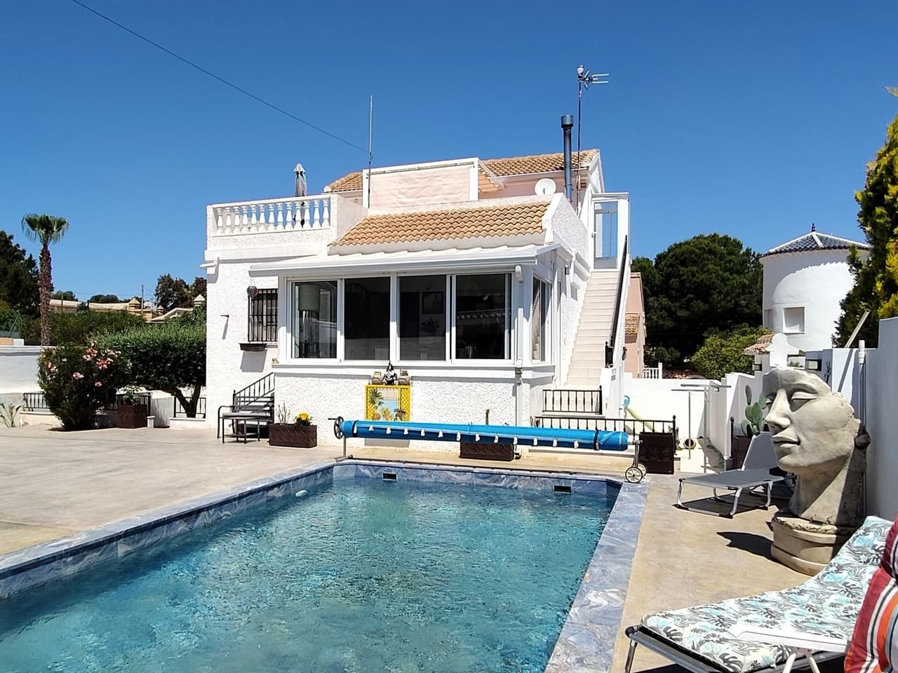 Find your perfect Mediterranean retreat with this exceptional 3-bedroom, 2-bathroom villa for sale in Vistabella. This detached property is fully equipped for modern living, powered by 15 high-efficiency solar panels and 3 storage batteries for eco-friendly peace of mind. The expansive outdoor grounds are a sun-drenched paradise, featuring a pristine, fully renovated private swimming pool, a secure closed garage with space for 2 cars, and an outdoor kitchen for unforgettable summer barbecues under the stars. Whether you are lounging by the poolside or entertaining guests, the incredible exterior space provides the perfect setting to embrace the relaxed Costa Blanca lifestyle.Step inside to explore a bright and beautifully modernised open-plan living space that effortlessly combines a contemporary kitchen, dining area, and a cosy lounge equipped with air conditioning and a feature wood burner for year-round comfort. The sleek, dark-toned kitchen is a chef's delight, complete with an elegant central island and integrated appliances, making it the perfect social hub for entertaining. Conveniently located on this main floor are two generously sized bedrooms. Upstairs, you will find the third bedroom, a second fully equipped kitchen, and a second bathroom, offering unparalleled privacy for visitors. This level leads out onto a spacious terrace where you can enjoy your morning coffee against a stunning backdrop of mountain views.The true hidden gem of this home lies below: a fully renovated basement featuring a rustic brick-and-stone wine cellar (bodega) with authentic arched bottle racks that promise to be the talking point of every dinner party.Golf enthusiasts will delight in the close proximity to Vistabella Golf, while the stunning, sandy beaches of the coast are just a short drive away. Conveniently connected to regional international airports for stress-free travel, this remarkable home is a rare find on the market.
