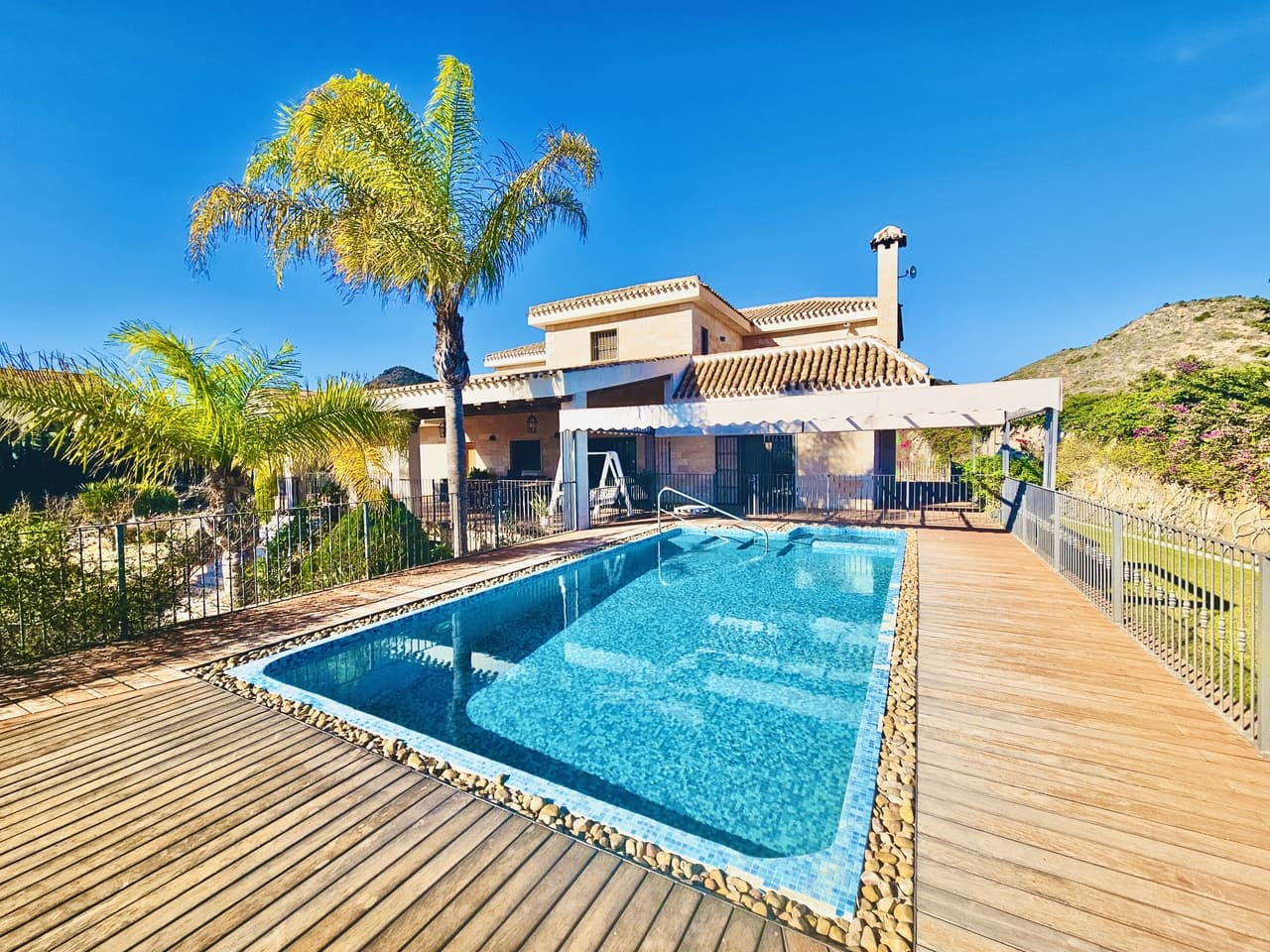 Welcome to Villa Laguna a spectacular 4 bedroom detached exclusive villa, located on the outskirts of the La Manga Club, a luxurious golf resort boasting three 18 hole golf courses, hotel and all the amenties you would expect from a first class resort. This impressive villa is built on huge plot, spanning over 13,000m2 accessed via a private driveway and two electric gates. Inside you will find the immaculate landscaped gardens with two beautiful ponds, waterfalls and a pretty streams along with a vineyard and various fruit trees along with a basketball and padel court and children's park. The villa itself ticks every single box you could wish for with elevator access from the 300m2 garage which has its own private bar and two private rooms which could be converted into extra living accommodation. Upstairs in the main house you will find the main living room, 2 double bedrooms with en-suite bathrooms, the office along with the fantastic kitchen with independent utility room and walk-in pantry. The is also access to the wraparound terrace and swimming pool, sun deck and bbq area with the most stunning views across the gardens.On the top floor of the property there are 2 en-suite bedrooms fitted with walk-in closets and en-suite bathrooms. Both have private access to the solarium with views out towards the sea. Built in 2006 this property has been built to a very high specification with many, many extras included and bespoke finishes. Perfectly situated, the villa is just a short 10 minute drive to Cabo De Palos with its designated Integral Marine Reserve, considered to be one of the best scuba diving sites in the Region. The villa is also just 25km from the airport.