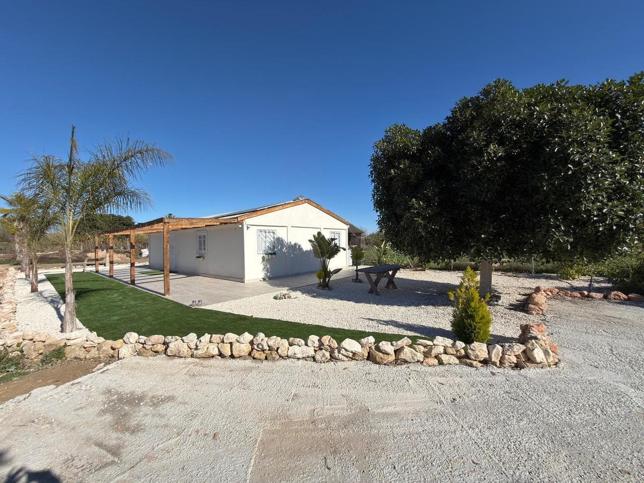 An amazing opportunity to buy this fantastic fully registered stables with RIGA license for 5 horses along with the beautiful unregistered Converted barn and storage block. This unique plot of land is located just a few minutes walk from Algorfa village and on the edge of Almoradi. It backs onto the river Segura, perfect for hacks and pretty walks. The plot has full 'off grid solar system', fresh water from the well, Star link internet with amazing signal and speed, gas water heaters, a brand new back up generator and with a fully alarmed cámara system throughout the plot which also has an irrigation system. The stables have automatic horse water feeds plus a brand new tack room and horse shower. The barn has been thoughtfully converted to include a master bedroom complete with a stunning en-suite bathroom along with a second bedroom and guest bathroom. This plot also boasts an additional 30m2 storage block, complete with two toilets. This is unique opportunity and viewing is recommended in order to be appreciated.
