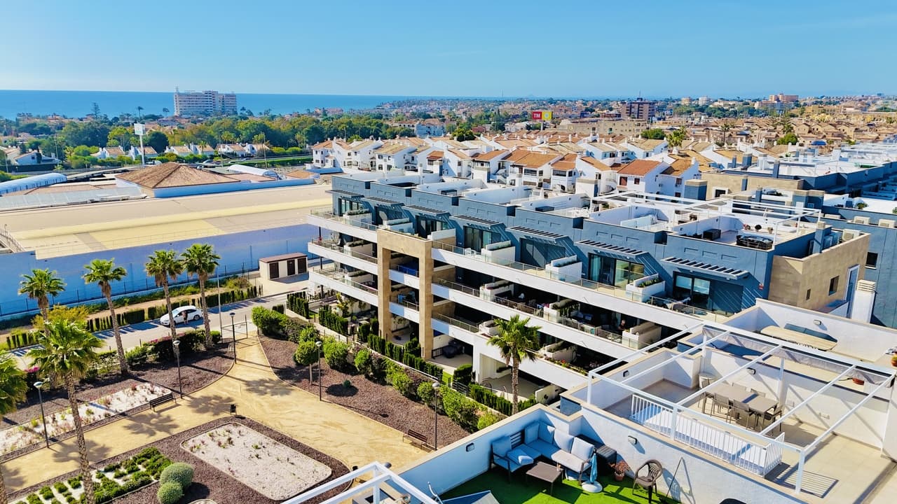 This brand new, modern apartment is located in the highly sought-after Flamenca Village and features a south-west facing balcony overlooking the beautifully maintained pool area.The exclusive urbanisation offers outstanding communal facilities, including four swimming pools (one of them heated), a fully equipped gym, landscaped promenade areas, and a pool bar, creating a resort-style living environment.The apartment is fully equipped and ready to move into, sold furnished and including appliances and air conditioning throughout.Upon entering the property, you are welcomed into a hallway leading directly to a bright and spacious open-plan living area with lounge, dining space, and modern kitchen. Large sliding doors open onto the generous 19 m² balcony, perfect for outdoor dining and relaxation.From the living area, a passage leads to the two bedrooms, a family bathroom, and a large storage room. The master bedroom benefits from an en-suite bathroom and also has sliding doors with direct access to the balcony.This is a turnkey property, ideal as a permanent residence, holiday home, or investment in one of the Costa Blanca’s most popular developments.