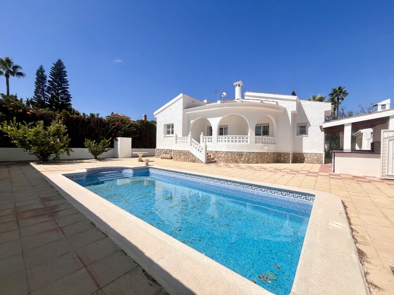A fantastic opportunity to own a 3 bedroom 2 bathroom detached Villa set on a generous 507m² corner plot in the highly desirable urbanization of Doña Pepa, Rojales. This beautiful south-facing detached villa designed for comfort, space, and Mediterranean living, this property is an excellent opportunity for those looking for a permanent residence, a holiday retreat, or an investment in one of the Costa Blanca’s most sought-after areas.The villa boasts a private swimming pool with plenty of sunbathing space, a private garage, and a large underbuild that offers endless possibilities, it can easily be converted into an additional bedroom, guest apartment, gym, or office. A spacious solarium provides the perfect spot to enjoy the Spanish sunshine while taking in peaceful surroundings, and the outdoor BBQ and summer kitchen area makes entertaining family and friends effortless.Inside, the property offers bright and spacious bedrooms, all with built-in wardrobes. The master suite includes a modern en-suite bathroom, creating a private retreat within the home. The living areas are generous, with plenty of natural light throughout, creating a warm and welcoming atmosphere.The villa is ideally located within walking distance of amenities, shops, and restaurants, and it is close to the 4* La Laguna Hotel & Spa, where you can enjoy luxury facilities year-round. For those who love the coast, the property is just a 10-minute drive to Torrevieja with its lively marina, shopping, and entertainment, and a short distance to the beautiful beaches of the Costa Blanca.This home combines peaceful residential living with easy access to everything the region has to offer — from golf courses and spas to fine dining and sandy beaches.With its large plot, modern features, and prime location, this villa offers everything you need for the perfect Mediterranean lifestyle.