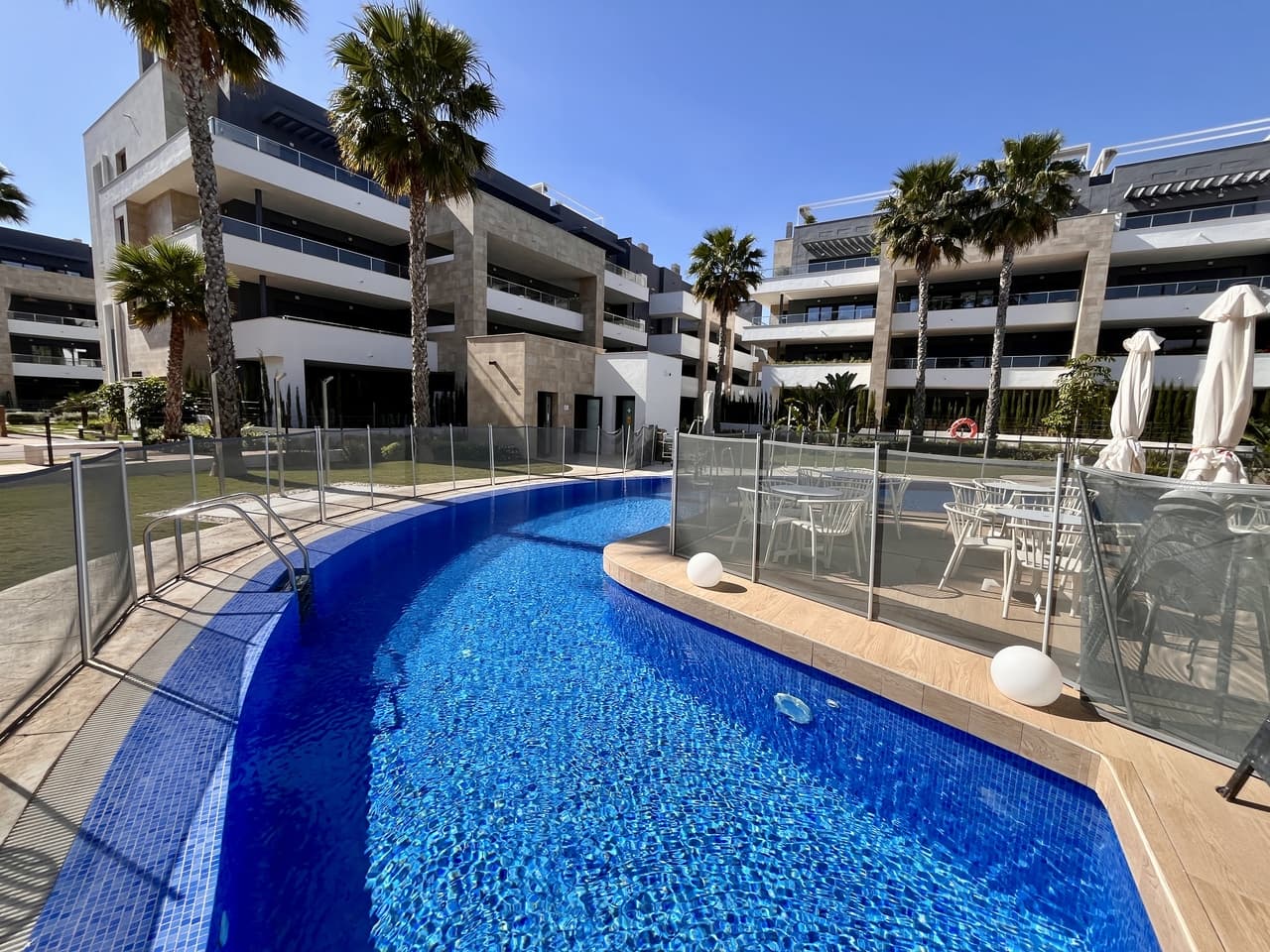 Fantastic opportunity to purchase this immaculate and well-presented key-ready 2-bedroom, 1-bathroom penthouse in Flamenca Village, Playa Flamenca. Situated in one of the most sought-after developments on the Orihuela Costa, this stunning penthouse offers a perfect blend of luxury, location, and lifestyle. Just a short stroll from the golden sands of Playa Flamenca and only minutes from Zenia Boulevard, this property is ideal as a holiday home, investment, or permanent residence.The apartment features two bright and spacious bedrooms, a stylish modern bathroom, and a beautifully finished open-plan living and dining area. The fully equipped kitchen comes with high-quality appliances, making it ready to enjoy from day one. The real showstopper is the private solarium, offering an exceptional outdoor space to soak up the sun, enjoy al fresco dining, or unwind under the stars.This exclusive gated community boasts resort-style amenities including four communal swimming pools (two of which are heated), several jacuzzis, a gym, sauna, beautifully landscaped gardens, and even a poolside bar with live music. It also includes underground parking, 24/7 security, high-speed Wi-Fi, and much more for your comfort and peace of mind.With everything you need on your doorstep – from restaurants and shops to beaches and entertainment – this penthouse offers an unbeatable lifestyle in the heart of Playa Flamenca.