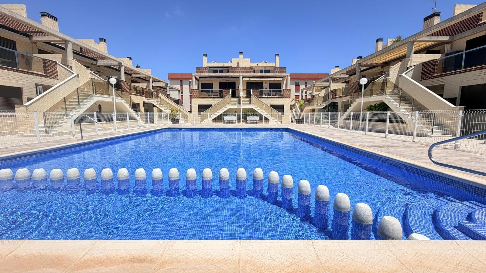 Discover the perfect blend of comfort, convenience, and Mediterranean living in this beautifully presented ground floor apartment, situated within an exclusive and secure gated community.Designed for effortless living, the property is offered fully furnished and comes complete with kitchen appliances, allowing you to move straight in and start enjoying your new home from day one. The apartment features three generously sized bedrooms and two well-appointed bathrooms, complemented by bright and inviting living spaces that flow seamlessly onto a spacious front terrace. Whether you're enjoying a morning coffee in the sunshine, dining al fresco with family and friends, or simply relaxing with a good book, this wonderful outdoor space provides the perfect setting.Every room benefits from air conditioning, ensuring year-round comfort, while the included underground parking space adds an extra level of convenience and security. The apartment's ground floor position offers easy access and enhances its appeal as both a permanent residence and a lock-up-and-leave holiday home.Residents enjoy access to an impressive range of resort-style facilities, including a large communal swimming pool, a fully equipped gym, sauna, and jacuzzi. Beautifully maintained gardens and communal areas create a peaceful and welcoming environment, allowing you to embrace a relaxed Mediterranean lifestyle every day.The location is equally attractive. Ideally positioned near the coast, the property is less than ten minutes from beautiful sandy beaches and a selection of renowned golf courses, making it an excellent choice for beach lovers and golf enthusiasts alike. For everyday convenience, a vibrant commercial area is just a short walk away, offering a fantastic selection of shops, cafés, bars, restaurants, and essential services, all within easy reach and less than ten minutes from your doorstep.Whether you are looking for a stylish permanent residence, a luxurious holiday retreat, or a smart investment with excellent rental potential, this exceptional apartment offers an outstanding opportunity to enjoy the very best of coastal living in a highly desirable location. Combining modern comfort, superb amenities, and excellent accessibility, it is a property that truly delivers on lifestyle, convenience, and value.