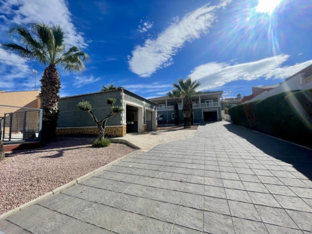 We are pleased to present this magnificent detached villa on a 1,100 m² plot, located just a few meters from the prestigious La Marquesa golf course in Rojales, as well as supermarkets, restaurants, and leisure areas.This luxurious property stands out for its spaciousness, brightness, and excellent finishes. Surrounded by extensive gardens, it features several garages and large outdoor spaces ideal for enjoying the Mediterranean climate year-round.The house offers 300 m² of living space, distributed over two floors:Main floor: Four spacious and bright bedrooms, one of them with an en-suite bathroom and direct access to a large terrace with stunning panoramic mountain views.A large, fully furnished living-dining room with access to a large terrace and beautiful views of the region.Separate and spacious kitchen, equipped with all necessary appliances and ready to move in. An additional full bathroom with a whirlpool tub, sink, toilet, and bidet.Ground floor/basement: Large living-dining room with a fireplace and direct access to the garden. Separate kitchen with laundry room, storage room, small gym, third full bathroom, and enclosed garage for two vehicles.Outside, the property includes a second separate enclosed garage with ample storage space. The house also has two entrances: one for vehicles on the north side and a main entrance facing south with a barbecue area ideal for outdoor gatherings.Unbeatable location: Just a 10-minute drive from the beaches of Guardamar del Segura and only 30 minutes from Alicante Airport.A unique opportunity for those seeking an exclusive home surrounded by peace and tranquility, with stunning views and all amenities within easy reach.Contact us at CASA Spanish Homes and come discover this spectacular villa.