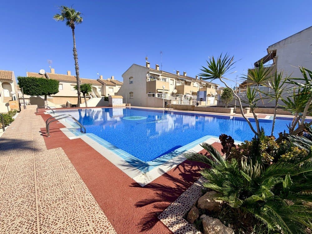 We present this magnificent ground-floor bungalow, located in one of the most sought-after areas of Torrevieja, specifically in the prestigious residential area of ​​Aguas Nuevas. An ideal property as a primary residence, second home, or investment, thanks to its excellent location, orientation, and layout.This welcoming 70 m² apartment stands out for its functionality and brightness, offering a warm and comfortable atmosphere year-round. Its southern exposure ensures a constant flow of natural light, creating pleasant and energy-efficient spaces.The interior features a spacious living-dining room, seamlessly integrated as the heart of the home, ideal for relaxation or gatherings. It includes two comfortable bedrooms, both well-ventilated and with built-in wardrobes that maximize storage space. The complete, practical, and well-maintained bathroom is complemented by a separate kitchen, providing greater privacy and versatility for everyday use.As an added bonus, the property includes a storage room, providing extra space that is very useful for organization.One of the great attractions of this property is its outdoor area. It features a charming covered porch, perfect for relaxing outdoors, along with a spacious, multifunctional terrace where you can design your own personalized space: a chill-out area, an outdoor dining area, or a barbecue area.In addition, the plot offers ample space for private parking, a highly valued feature in the area.The property is located in a quiet, well-maintained residential complex with ample communal areas, including a swimming pool and landscaped gardens. These are ideal spaces for strolling or enjoying the Mediterranean climate. Its location is strategic: just minutes from all essential services such as supermarkets, restaurants, shopping centers, and public transport. Furthermore, it is only 1.5 km from the coast, which is about a 15-minute walk to the beaches.Main features: Semi-detached house on the ground floor, 65 m² built, 2 bedrooms, 1 bathroom, spacious living-dining room, separate kitchen, terrace, porch and outdoor space, fitted wardrobes, storage room, south facing, second-hand in good condition, Air conditioning, communal pool, garden and green areas. This property represents an excellent opportunity for those seeking quality of life, sunshine, and tranquility near the sea, in one of the most sought-after areas of the Costa Blanca. Ready to move in and enjoy from day one.Contact us to see the property!!