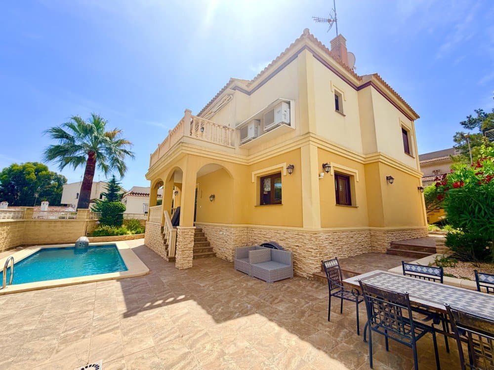 Presenting an exceptional detached villa that effortlessly combines timeless elegance, generous living spaces, and the very best of Mediterranean outdoor living. Set on a beautifully landscaped 400 m² plot, this impressive residence offers 191 m² of meticulously maintained accommodation and is ready to be enjoyed from day one.Designed for both relaxation and entertaining, the outdoor spaces are a true highlight. A stunning private swimming pool takes centre stage, surrounded by an amazing garden, sun-drenched terraces, and inviting areas for al fresco dining, summer barbecues, and memorable gatherings with family and friends.Inside, the villa welcomes you with a bright and airy living room featuring soaring ceilings and a charming wood-burning fireplace, creating a warm yet sophisticated atmosphere. The ground floor also offers a spacious double bedroom with fitted wardrobes, a stylish bathroom with laundry area, and a fully equipped kitchen complete with appliances. From here, doors open onto a delightful terrace overlooking the gardens and pool, seamlessly blending indoor and outdoor living.The upper floor continues to impress with a second elegant lounge and two exceptionally spacious bedrooms. The principal suite boasts a walk-in wardrobe and direct access to a beautiful private terrace shaded by a wooden pergola an idyllic retreat for morning coffee or evening relaxation. The second bedroom features fitted wardrobes and is served by a well-appointed bathroom with double vanity. A further terrace accessed from the lounge enjoys pleasant views over the surrounding area.Ideally situated within walking distance of the vibrant La Zenia Boulevard shopping centre and the golden sands of La Zenia Beach, this remarkable home offers an enviable lifestyle in one of the Costa Blanca’s most sought-after locations.Additional features include full furnishings, air conditioning throughout the bedrooms and lounges, central heating via radiators, and energy-efficient solar panels, owning in terrace providing year-round comfort and enhanced sustainability.A distinguished villa offering space, style, and an unbeatable location just moments from the coast.