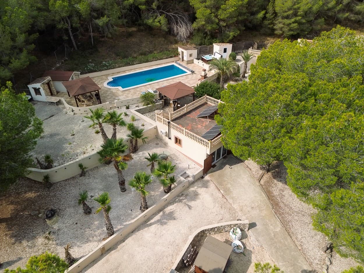 Nestled in the heart of the Torremendo countryside, surrounded by Mediterranean nature and sweeping open views, this magnificent two storey detached villa offers the perfect blend of comfort, privacy, and rural charm. Set on an impressive 11,000 m² plot, surrounded by forest the property provides peace, space, and endless possibilities for those seeking a unique lifestyle in a natural setting.

The main house features four spacious bedrooms,two in the ground floor and two in the top floor, all filled with natural light and offering plenty of room for cozy, personalized spaces. There are two full bathrooms inside the home, plus an additional outdoor toilet by the pool—a thoughtful touch for convenience during long summer days outdoors.

The main living room is the heart of the villa, boasting a traditional wood fireplace that creates a warm, welcoming atmosphere, perfect for relaxing evenings in the cooler months. The fairly new kitchen with an independent island combines functionality and style, offering a central hub for family life and entertaining guests.

Outdoors, the property truly shines. The private swimming pool is surrounded by sun terraces and relaxation areas, while a raised terrace with jacuzzi offers panoramic views of the surrounding countryside, making it an ideal spot for dining al fresco or simply soaking in the tranquility. The estate also includes three garages, providing ample space for vehicles, storage, or workshops.

Equestrian enthusiasts will appreciate the horse stables, paddock tack room and Rega for 5 horses, designed to accommodate and care for animals in comfort, Additionally, the installation of solar panels ensures greater energy efficiency and sustainability, perfectly aligning with the villa’s natural surroundings.

With its privileged location, surrounded by rolling fields and peaceful landscapes, this property is perfect as a permanent residence for those seeking a serene lifestyle, or as a countryside retreat away from the bustle of the city. Combining modern amenities with the beauty of nature, this villa offers a truly exceptional way of living in Torremendo.