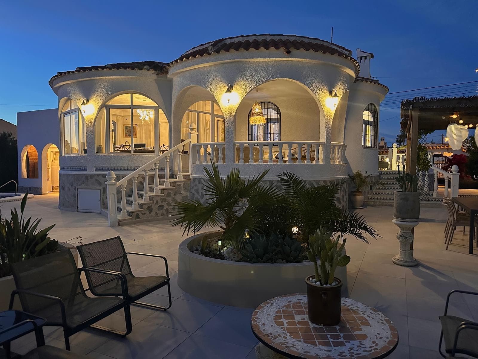 Introducing this beautifully presented three-bedroom, two-bathroom detached villa, ideally located in the highly sought-after neighborhood of El Chaparral / San Luis - Costa Blanca South. Set on a generous plot of approximately 800 m², this property offers a rare blend of privacy, space, and refined style. Surrounded by privacy walls and accessed via a secure entrance, the villa boasts a tranquil and inviting ambiance from the moment you arrive.The home has been thoughtfully updated to a high standard, blending clean Nordic design with the warmth of traditional Spanish elements. The result is a harmonious and welcoming interior that feels both contemporary and timeless. The spacious, glass-enclosed veranda overlooks the stunning pool area with salt water pool and manicured, low-maintenance gardens, creating a seamless indoor-outdoor living experience that can be enjoyed year-round. The propeties gardens have a coveted southwest-facing orientation, bathed in natural sunlight throughout the day—perfect for sunseekers and al fresco entertaining. Various chill out zones, salt water pool, dining areas, solarium with view to the salt lake and outdoor kitchen really complete this outdoor oasis. The gardens are full of fruiting trees inc: orange, blood orange, mandarin, lemon, mango and olive.Additional features include off-road parking, a dedicated storage area, an outdoor full bathroom for poolside convenience, and beautifully tiled exteriors designed for easy upkeep. Every corner of this home has been carefully considered to maximize comfort, style, and functionality.Ideally situated just moments from local amenities, with easy access to Torrevieja, the Habaneras shopping centre, and the beaches of the Costa Blanca, this villa offers both convenience and a serene lifestyle setting. Whether you’re looking for a permanent residence, a holiday retreat, or a smart investment, this is a property not to be missed.