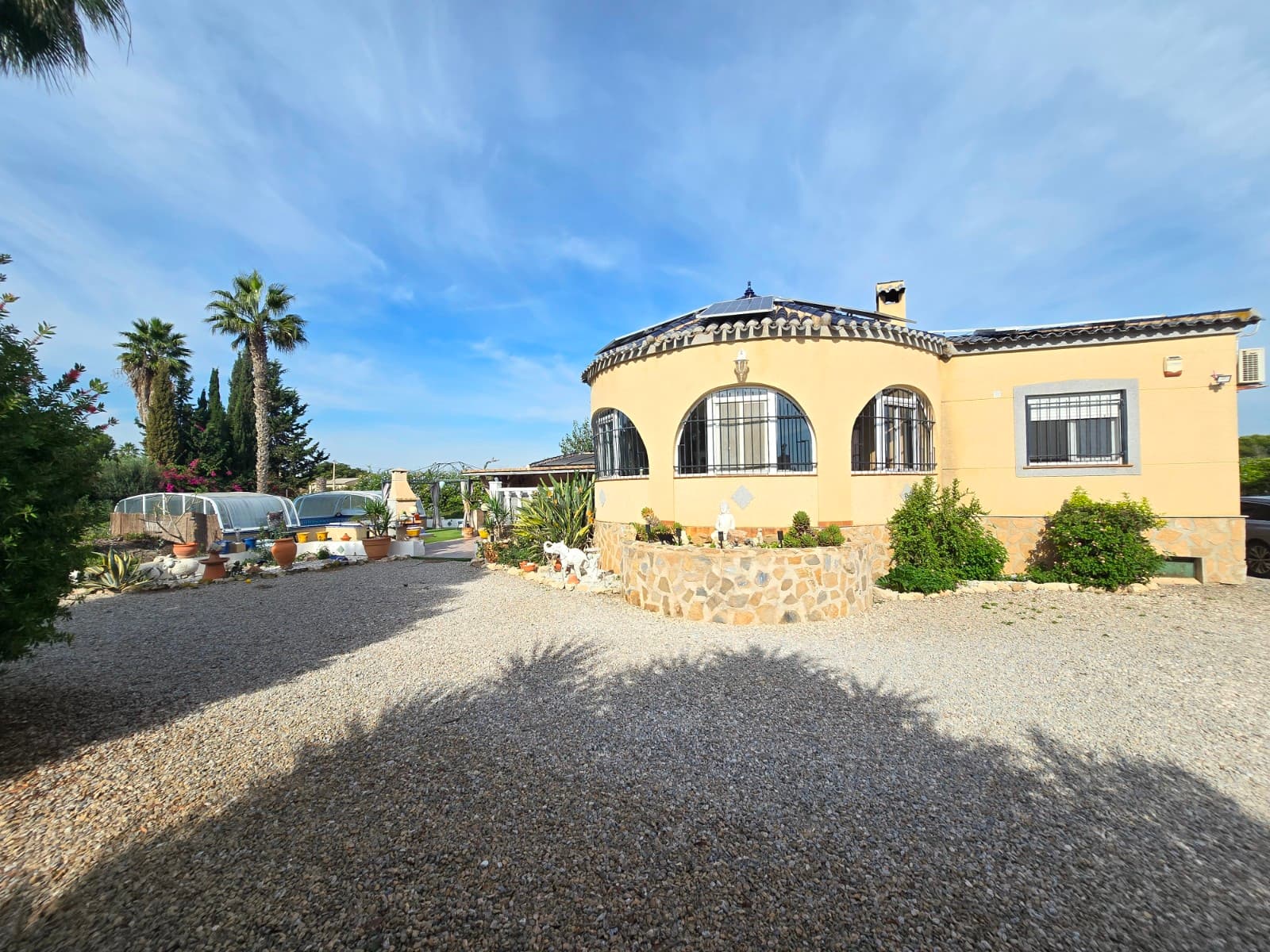 This spacious house is located a short distance from the center of Dolores, on a large plot that offers a wonderful sense of privacy and tranquility.



Dolores is a typical Spanish village, known for its charming village square with various bars, restaurants, and specialty shops. This charming village has a weekly market and hosts numerous festivals.

Thanks to its central location, you can also quickly reach the airport, numerous other towns, golf courses, shopping centers, and of course, the many beautiful sandy beaches the region has to offer.



There's no shortage of space in this beautiful rustic house!

The house features a cozy living room surrounded by a living veranda, which opens onto a spacious kitchen. Further along the small landing, you'll find the master bedroom with an ensuite bathroom, the second double bedroom, a family bathroom, and a third bedroom currently used as a dressing room.

Adjacent to the house is a spacious garage for additional storage.

Nowhere is there a better way to enjoy the Spanish climate than in the beautiful garden of this house! Naturally, the property features a heated swimming pool, a spacious pool house/casita, a large covered terrace, an outdoor shower, a jacuzzi with adjoining full bathroom, a pétanque court, a mini golf course, and numerous cozy corners for relaxing.



This property also boasts solar panels, a heated swimming pool, various native fruit trees, garden irrigation, a renovated septic tank, electricity connections, a pellet stove, and much more.

THIS PROPERTY IS COMPLETELY BUILT AND EQUIPPED WITH ALL THE NECESSARY DOCUMENTS!



So don't hesitate and book a viewing of this beautiful home in the Spanish countryside today!



Total: €328/year.