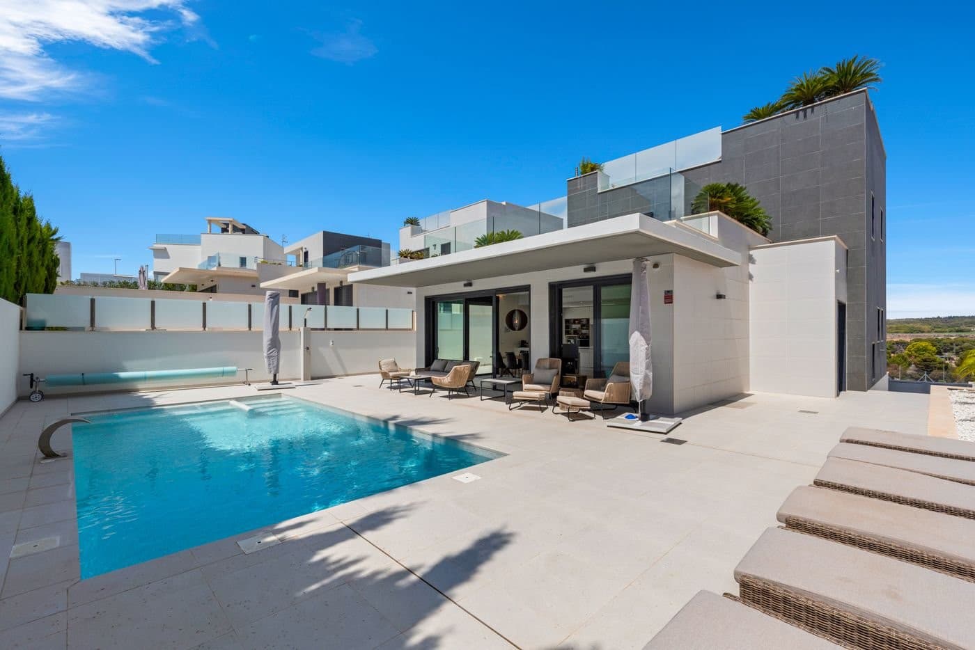 We proudly present this impressive villa, built in 2020, now available for sale!Located on a peaceful residential street in Campoamor, this villa offers the perfect combination of modern design and practical comfort. Everything you need is within easy reach.Ground Floor: Bright, airy, and invitingAs you enter the villa, you are greeted by a bright, modern kitchen seamlessly connected to a spacious dining area and cozy TV lounge. Large windows with patio doors open onto the terrace, creating a fluid transition between indoor and outdoor living, filling the space with natural light and a sense of openness. Adjacent to the living room is a practical covered terrace with a stunning view of the pool.Bedrooms and Bathrooms: Space and comfortThe ground floor features a large, spacious bedroom with an ensuite bathroom, as well as another spacious bedroom and a bathroom, both with shower cabins.On the first floor, you will find two additional bedrooms and two bathrooms, one of which is an ensuite, also both with shower cabins. There is access to a large terrace from both the bedroom and the hallway, perfect for relaxation. At the opposite end of the hallway, an exterior staircase leads to a fantastic rooftop terrace with a breathtaking view, where you can enjoy the starry sky and city lights as night falls.Three of the bathrooms have double sinks and are spacious and well-appointed. All bathrooms have electric floor heating.All bedrooms are equipped with large, built-in wardrobes. The house also features an airzone system, providing both cooling and heating, ensuring the perfect temperature in every room.Basement and Outdoor Spaces: Opportunities and enjoymentThe villa has a full basement under the entire house. There is a large laundry room with plenty of storage space. The spacious basement offers ample opportunity to create exactly what you desire—additional bedrooms, a wine cellar, a game room, or whatever you envision.Outside, there are plenty of opportunities to enjoy the sun and the beautiful climate. The garden is tiled with some stone-paved beds featuring small palm trees and a fruitful lemon tree, creating a cozy atmosphere. The pool can be enjoyed all year round, thanks to the pool heating system.There is also parking available on the property.Location: Everything within reachThe location is ideal, with walking distance to the Consum supermarket and the beach in Campoamor. Several restaurants are also within walking distance, and there is easy access to both the N-332 and AP7 motorways.Partially Furnished: Ready to Move InThe house is sold furnished (except for the garden furniture), so you can move right in and start enjoying your new home immediately.This is a unique opportunity for those dreaming of a modern villa with plenty of space both inside and out.Book a viewing today and let this fantastic property inspire you!