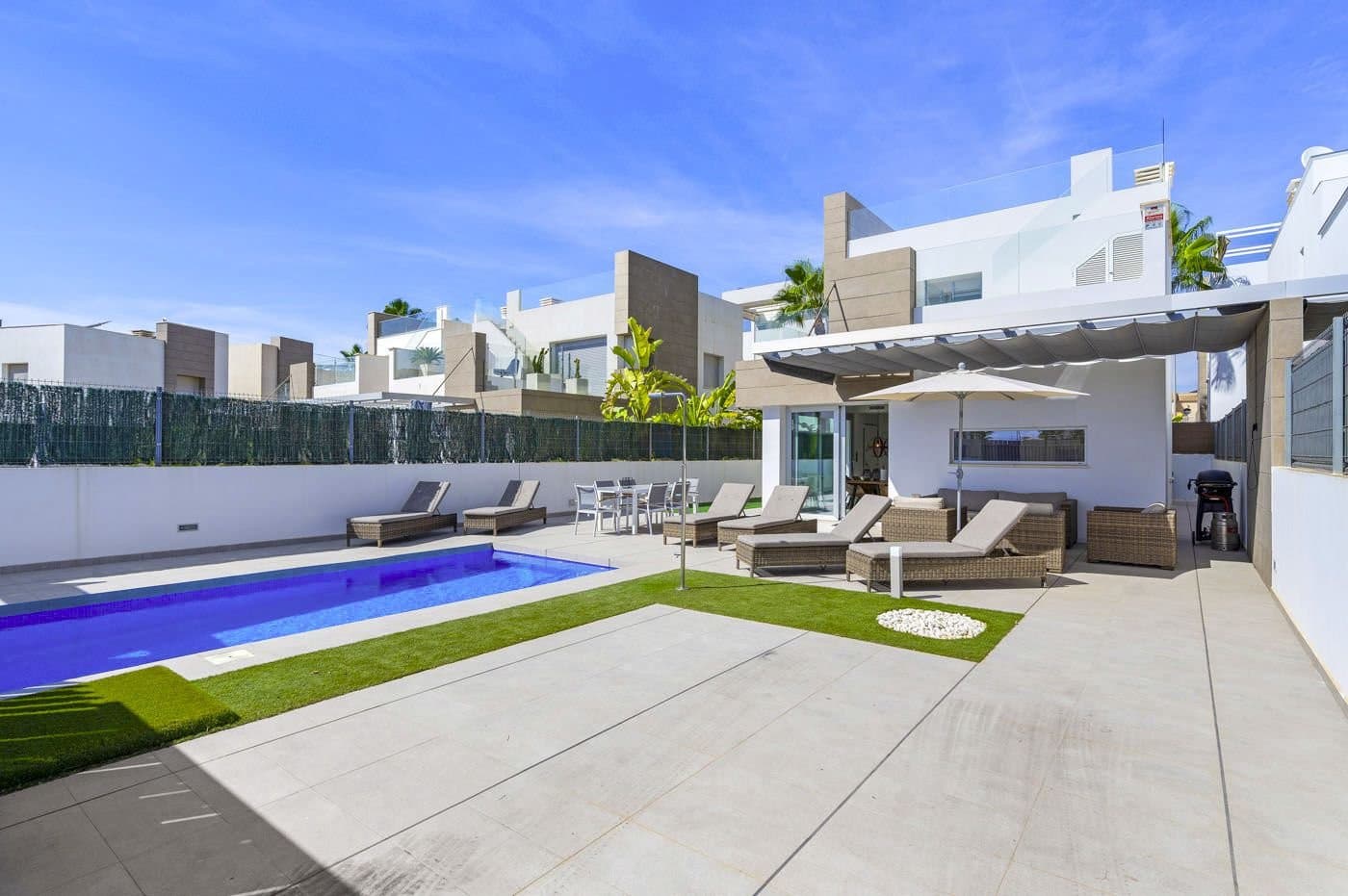 We are delighted to present this modern villa in El Raso, built in 2019, offering a stylish home and fantastic outdoor areas that will make you long for sunny days and starry nights.The villa boasts a spacious, private garden with its own heated pool – perfect for both relaxation and fun in the sun. With plenty of space for sunbathing and a convenient pergola for when you need some shade. Your car can be parked safely on the property, and the enclosed area ensures complete privacy.Bright and modern interior designInside, you’ll find a bright, open living room with a modern design and large windows that invite in natural light and create a seamless connection to the garden. The kitchen is well-equipped and includes a practical kitchen island, functioning as the perfect gathering spot when family and friends are over. The kitchen and dining area blend together into one large, cozy space.On the ground floor, there is also a spacious bedroom with an ensuite bathroom. Here you’ll have two sinks and a roomy shower cabin. Additionally, there is a guest toilet, making everyday life a bit easier.Spacious first floor with terraces and rooftopThe elegant staircase takes you up to the first floor, where you will find two additional large bedrooms, both with built-in wardrobes and plenty of natural light. There is another bathroom with double sinks and a shower cabin, perfect for the family’s needs.From the first floor, you have access to two fantastic terraces, and a staircase leads further up to the villa’s impressive rooftop terrace. Here, you can enjoy uninterrupted panoramic views, create small outdoor oases, or even set up an outdoor kitchen – the possibilities are endless. This is an ideal spot for family holidays, where you can be together but also find peace to enjoy the private spaces.Modern comfort and convenienceThe villa is equipped with underfloor heating in the bathrooms, as well as air conditioning via a central system, which can both cool and heat the home, ensuring comfort year-round. The windows in the bedrooms have electric shutters, making it easy to darken the rooms as needed.The house is sold almost fully furnished – ready to become your new home!Fantastic Location in El RasoEl Raso is a peaceful area with plenty of new modern developments, as well as older homes in a traditional Spanish style. You are just 37 km from Alicante Airport, making travel to and from the area easy. The Sunday lemontree market is close by, and you can enjoy a short walk there without having to worry about parking.Additionally, you are only 1 km from restaurants, a bazaar, and a pharmacy, and just 5 minutes&039; drive from Consum Supermarket. If you want to enjoy the beautiful beach of Guardamar del Segura, you can be there in under 10 minutes by car.This beach is just perfect!Book a viewing of this wonderful house and get a taste of your dream holiday home.Plot 300 m2Build ground floor 64 m2Build 1st floor 40 m2Terrace 1st floor 29 m2Roof terrace 43 m2Total built 176 m2