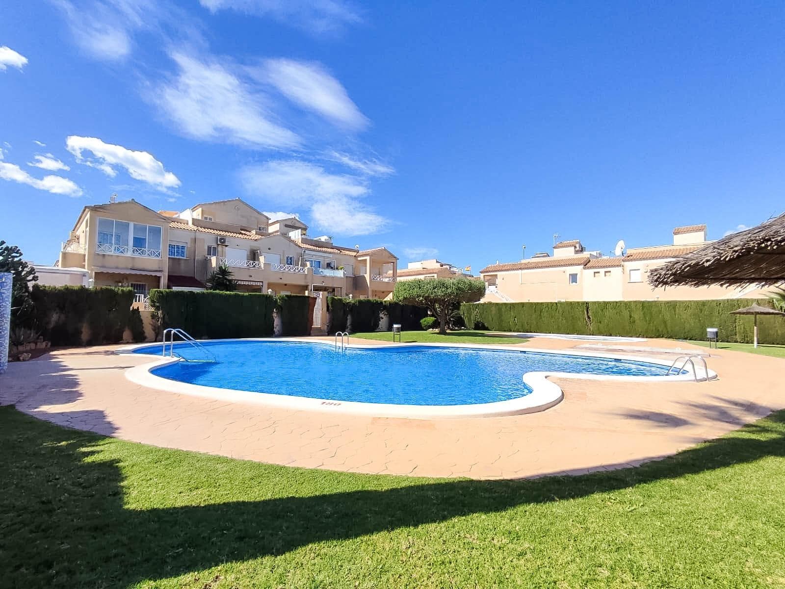 Bright and fully furnished 2-bedroom penthouse bungalow with a spacious 26 m² rooftop solarium and a private 53 m² plot, located in the gated community "Europa" with a swimming pool and green park. An optional garage is available for purchase. Address: Calle Ramón Imbernón Verdú, Torrevieja — an ideal central location: opposite the Consum supermarket, near Carrefour, Habaneras shopping center, shops, cafes, and all urban infrastructure within walking distance. Property Features: - Living area: 61 m² - Entrance terrace: 10 m² with installed awnings - Private front plot: 53 m² with gate and parking - Rooftop solarium: 26 m² - Separate garage with electronic doors - 2 bright and cozy bedrooms - Separate fully equipped kitchen - Glazed laundry area next to the kitchen - South-facing windows — maximum sun all year round - Fully furnished with appliances - Air conditioning for heating and cooling - Fresh paint, quality curtains, chandeliers, and security bars on the windows The property is situated in a well-maintained residential complex with a pool, green areas, and a cozy, secure atmosphere. Ideal for year-round living, a holiday home, or rental investment. Don't miss the chance to acquire a ready-to-move-in home in the center of Torrevieja with excellent infrastructure and sunny comfort!