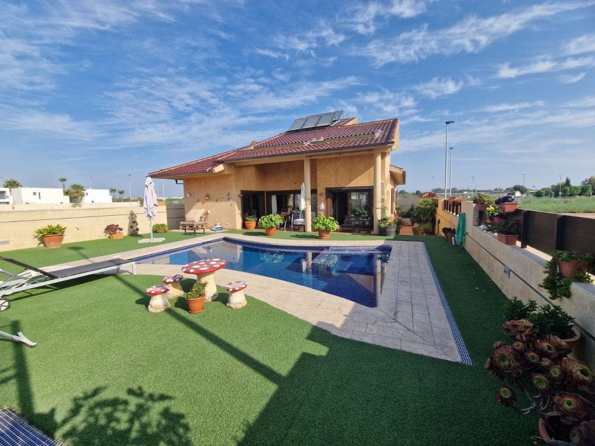 Discover the epitome of luxury living in this stunning 4-bedroom, 3-bathroom villa located in the serene and sought-after area of Santiago de la Ribera. Nestled in a peaceful neighborhood yet just a 5-minute drive from the pristine beaches of the Mar Menor and the vibrant Dos Mares shopping center, this villa offers the perfect blend of tranquility and convenience. Set on an expansive 784 m² plot, this property boasts an array of exceptional features designed to cater to every aspect of modern living. The beautifully landscaped garden, adorned with mature tropical plants, surrounds a private pool and a charming casita equipped with shower facilities. A unique highlight is the football pitch, which has been reinforced to support the construction of an additional house if desired. As you enter the villa, you are greeted by a welcoming hallway that seamlessly leads you into various sections of the home. To the right, three spacious double bedrooms with custom-made wooden wardrobes share a stylish family bathroom, providing ample space and comfort for family and guests alike. On the left side of the villa, the luxurious master suite awaits, complete with a separate walk-in wardrobe and en-suite bathroom. Large sliding doors from the master bedroom open onto the terrace, offering direct access to the pool area. The heart of the home is the impressive living room, accessible through exquisite stained-glass doors. The room’s lofty ceilings create a sense of grandeur, while large sliding doors flood the space with natural light and provide seamless access to the terrace and outdoor living areas. Adjacent to the living room, the spacious, fully equipped kitchen also opens onto the terrace, making it ideal for both indoor and outdoor entertainment. Practicality meets luxury with the inclusion of a utility room that opens onto the back patio. Additionally, an internal staircase leads to a vast under build, spanning the entire footprint of the house. This versatile space offers parking for up to eleven cars, a home gym, a dedicated entertainment room with a custom-built wine rack, and several secure storage rooms. It also includes a large emergency water deposit, offering peace of mind. Additional features of this remarkable property include marble boundary walls sourced from Almería, a pre-installed lift shaft ready for cabin installation, pre-installed ducted air conditioning, and underfloor heating powered by mains natural gas. The owner’s favorite aspects of the villa include the direct access from the kitchen, living room, and master bedroom to the terrace and pool area, as well as the well-utilized home gym. The peaceful location, combined with proximity to the beach and shopping center, makes this an ideal family retreat. In summary, this villa is an extraordinary property that must be seen to be fully appreciated. With its spacious rooms, unique architectural features, meticulously maintained outdoor spaces, and one-of-a-kind underbuilding, it offers unparalleled luxury and endless possibilities. We highly recommend arranging a viewing to experience this exceptional home firsthand.