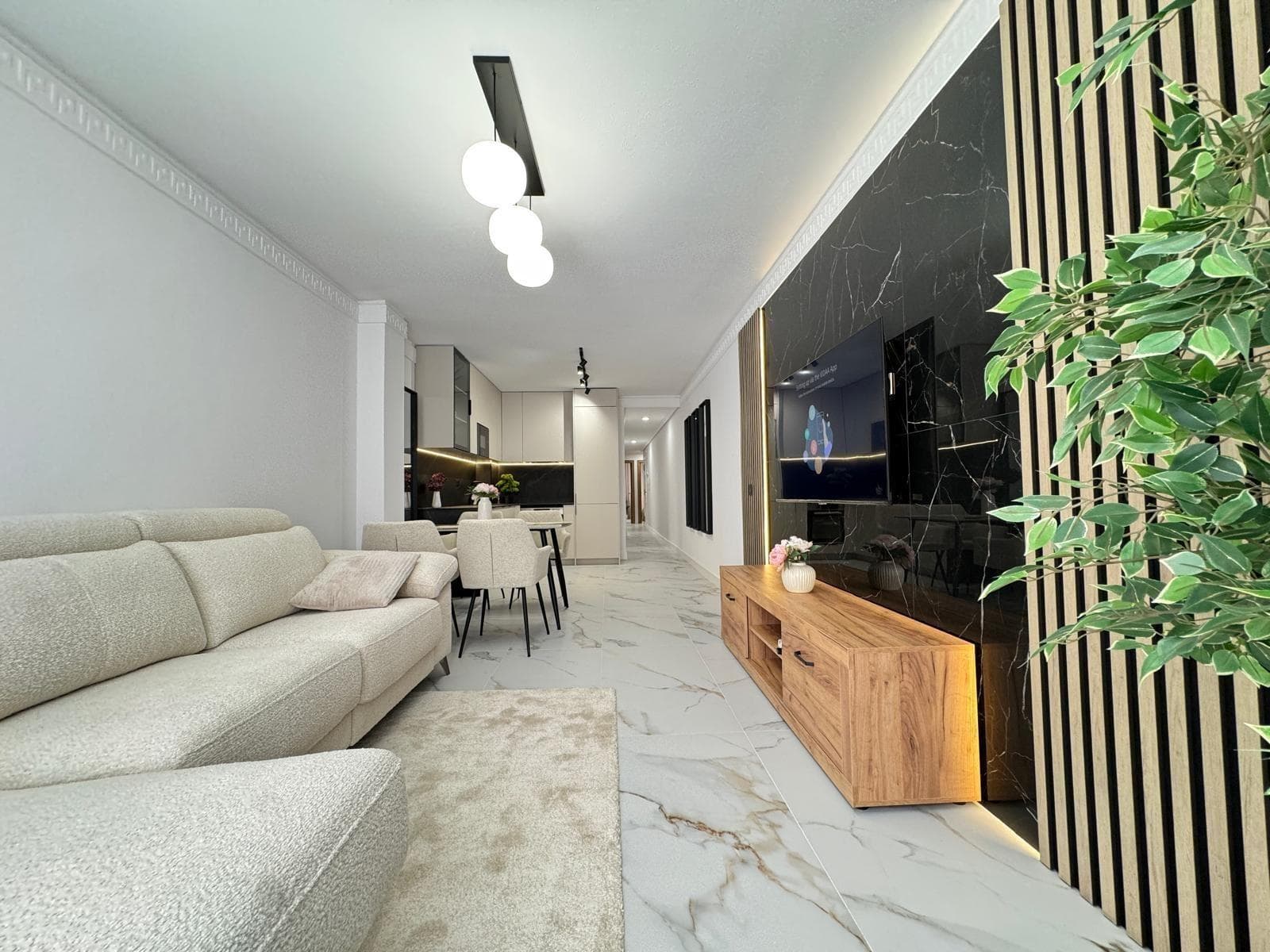 Completely Renovated 4-Bedroom Apartment 50 Meters from the Sea – Calle Palangre, Torrevieja We present this fantastic opportunity to acquire a completely renovated, brand-new apartment located on the prestigious Calle Palangre, one of Torrevieja's most sought-after areas. Just 50 meters, or a one-minute walk from the sea, you'll enjoy the Mediterranean breeze and a privileged setting. The apartment is located on the first floor with an elevator and has a total area of ​​105 m², perfectly distributed to offer spaciousness, functionality, and comfort. The apartment has four bedrooms, all exterior, thanks to the fact that all the windows face the street, ensuring excellent ventilation and natural light. The living area offers a living-dining room integrated with the kitchen, creating a modern, comfortable, and highly practical space. It also has two full bathrooms, completely renovated and equipped with high-quality materials and contemporary designs. Among the most notable improvements of the complete renovation are: ✔️ New, elegant, and high-quality doors. ✔️ Completely new electrical and plumbing systems. ✔️ Completely renovated bathrooms, ready to move in. ✔️ Walls and ceilings painted in neutral tones for brightness and elegance. ✔️ Durable, easy-to-maintain porcelain stoneware flooring. ✔️ Granite tiles for a touch of distinction and durability. ✔️ New, modern kitchen equipped with top-brand appliances: dishwasher, oven, induction hob, extractor hood, and microwave. To ensure maximum comfort year-round, the home has three air conditioners, strategically placed to provide an ideal microclimate in each room. The apartment comes fully furnished, as shown in the photos, with new, elegant, and functional furniture, as well as decorative details that create a cozy and modern atmosphere, ready to move into. This apartment is an ideal choice both as a permanent residence or for those looking for a second home by the sea, without the need for any renovations or additional investments. Its location is unbeatable, in a quiet area yet very close to all amenities: supermarkets, restaurants, pharmacies, public transportation, and, of course, the best beaches in Torrevieja are just a stone's throw away.