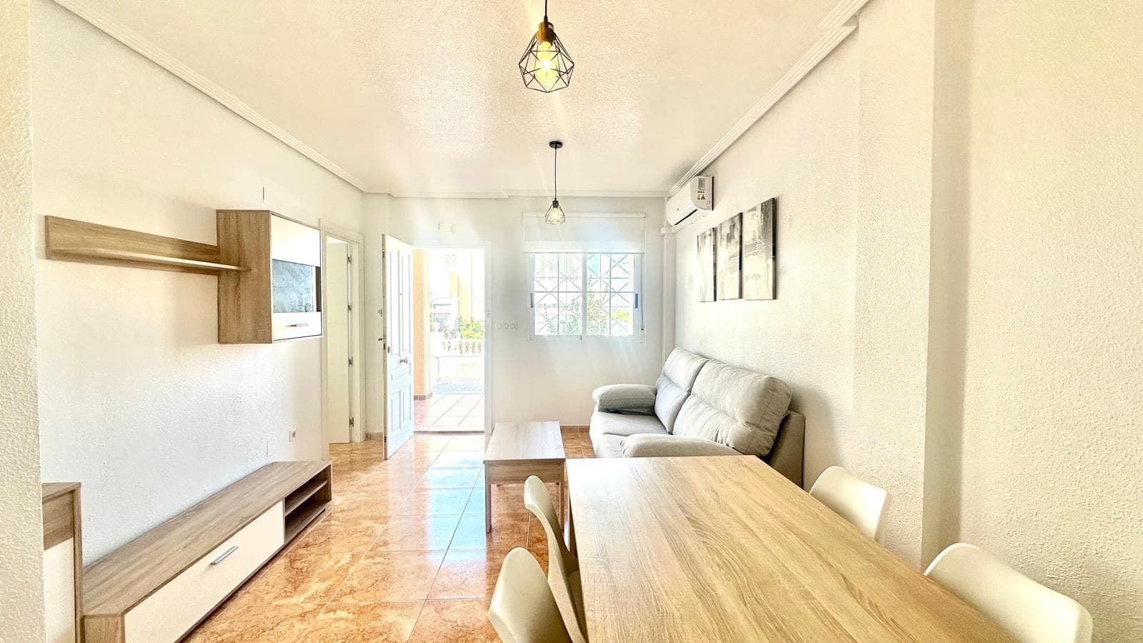 Ground floor bungalow between Parque de las Naciones, Molino and Habaneras — comfort, style and a prime location We present this charming ground floor bungalow, located in one of the most sought-after areas of Torrevieja, specifically between Parque de las Naciones, Molino and the Habaneras shopping centre. Its excellent location allows you to enjoy a quiet and well-connected environment, with all services and leisure areas just a few minutes away. The property has been completely renovated and offers a modern and functional design, ready to move into. It has two spacious bedrooms, a full bathroom with shower tray, and a cosy living-dining room that blends harmoniously with a separate open-plan kitchen, equipped with a utility room and all the necessary appliances for everyday use. One of the main attractions of this property is its large front courtyard, a private outdoor space that allows parking within the plot itself, something that is increasingly valued for its convenience and security. This courtyard can also be used for outdoor enjoyment, ideal for family meals, gatherings with friends or simply relaxing at the end of the day. The property faces north, which guarantees a cool and pleasant indoor temperature during the warmer months of the year, making this home a very comfortable option in both summer and winter. Thanks to its recent renovation, the bungalow features modern finishes and quality materials, giving it a contemporary look and a high level of comfort. All this, combined with its strategic location, makes this property an excellent investment opportunity or the ideal residence for year-round living in one of the most complete areas of Torrevieja. In short, this is a property that combines practicality, style and an excellent location, offering a space that is ready to enjoy without the need for additional renovations.