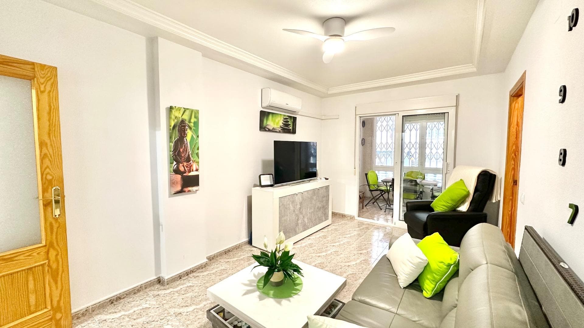 Located on Calle Félix Rodríguez de la Fuente, in a convenient and well-connected area of Torrevieja, this pleasant ground floor flat is just 750 metres from Playa del Cura, one of the city's most popular beaches. Its strategic location allows you to enjoy the proximity to the sea while having immediate access to all essential services: supermarkets, shops, medical centres, restaurants, public transport stops and leisure areas. The property has a comfortable and functional layout, comprising two bedrooms, perfect for residential use, for receiving guests or for using one of them as an office. The recently refurbished bathroom has a modern and practical design, in keeping with the improvements made to different rooms in the house, giving an overall feeling of care and modernity. The kitchen is separate, offering a space that is perfectly separated from the rest of the property for greater organisation. From here you can access a bright interior courtyard, which is very useful as a ventilation area, laundry room or storage space, as well as providing natural light to this area of the property. The living-dining room is a spacious and comfortable room, ideal for both relaxation and family gatherings. The property has air conditioning in the living room, ensuring adequate climate control during the hottest months. One of the most attractive spaces is the west-facing glazed terrace, a perfect spot to enjoy the afternoon light and make the most of an additional room throughout the year, whether as a relaxation area, auxiliary dining room or leisure area. In short, this ground floor flat on Calle Félix Rodríguez de la Fuente represents a magnificent opportunity for those looking for a comfortable, partially renovated and well-located property, close to the beach and surrounded by all the necessary amenities for a practical and comfortable daily life, both as a permanent residence and as an investment.