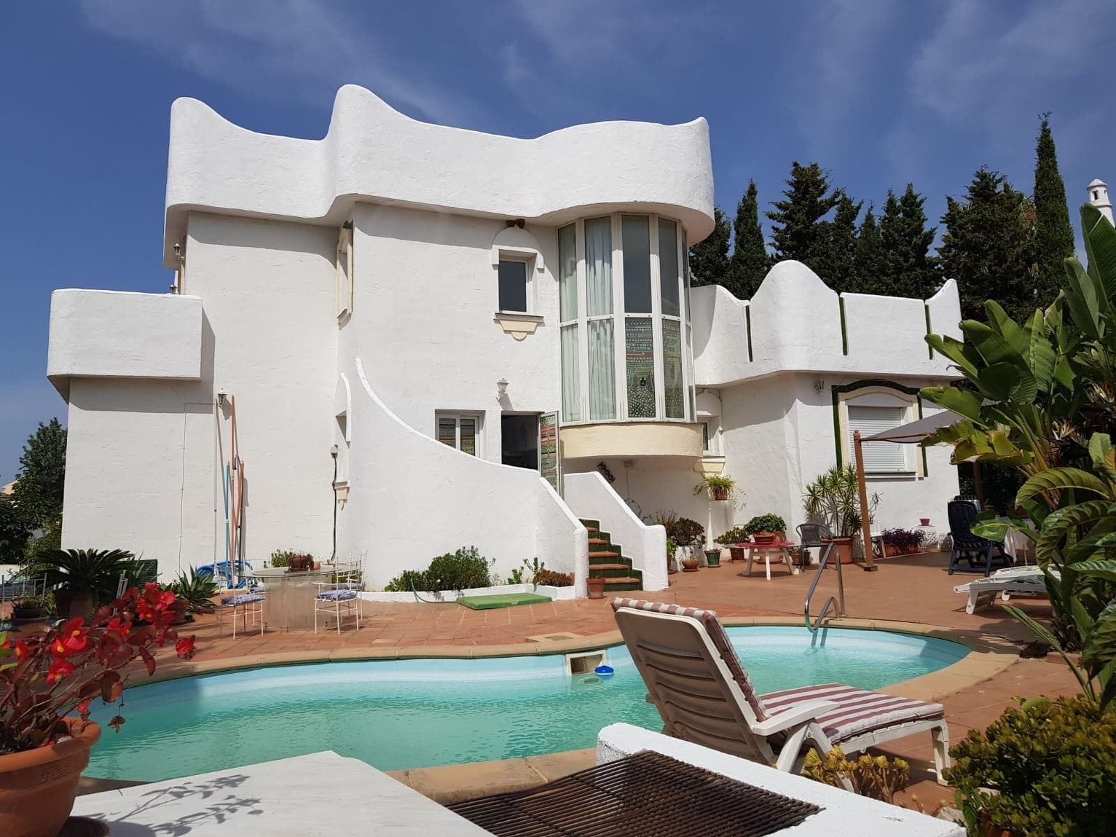 This is your chance to acquire a truly unique villa in the desirable area of Marbella East, just a few minutes' walk from the beach. Set on a generous 770 m² plot with a private pool and manicured garden, this property blends Mediterranean charm with architectural individuality — making it a fantastic option for personal enjoyment or as a high-potential investment. Key Features 276 m² built area 3 spacious bedrooms 3 bathrooms Separate kitchen with potential for open-plan design Bright interiors with high ceilings Storage room Private swimming pool Well-maintained, mature garden Unique Mediterranean architecture Quiet and private location Walking distance to the beach A Villa Full of Character, Light & Space This villa stands out with its striking architectural lines and flowing curves, setting it apart from typical properties in the area. Inside, the home welcomes you with open, airy spaces, abundant natural light, and high ceilings that create a sense of volume and elegance. The current layout includes a separate kitchen, ideal for those who enjoy traditional cooking spaces — though the configuration allows easy remodeling into an open-plan living-dining-kitchen area if preferred. The three bedrooms offer comfort and privacy, each with its own charm, and the bathrooms are well-kept and ready for modern updates. Lifestyle & Investment Benefits The private pool is the focal point of outdoor living here, surrounded by a lush garden filled with palms and Mediterranean plants. The 770 m² plot offers both peace and potential — a spacious setting for family life or a solid base for a design-led renovation project. With its excellent location — within walking distance of Marbella’s golden beaches, close to international schools, golf clubs, and restaurants — the property offers outstanding value, particularly in a market where modernised villas in similar settings command significantly higher prices. Why This Villa Makes Sense Great renovation potential: A tasteful upgrade could increase the value by 30–40% Ideal for investors, developers, or end-users Hard-to-find location: beach proximity, privacy, and generous plot size Classic Marbella lifestyle with a unique architectural twist Whether you're looking for a family home, a project with strong upside, or a holiday escape with room to personalise, this villa delivers on all fronts.
