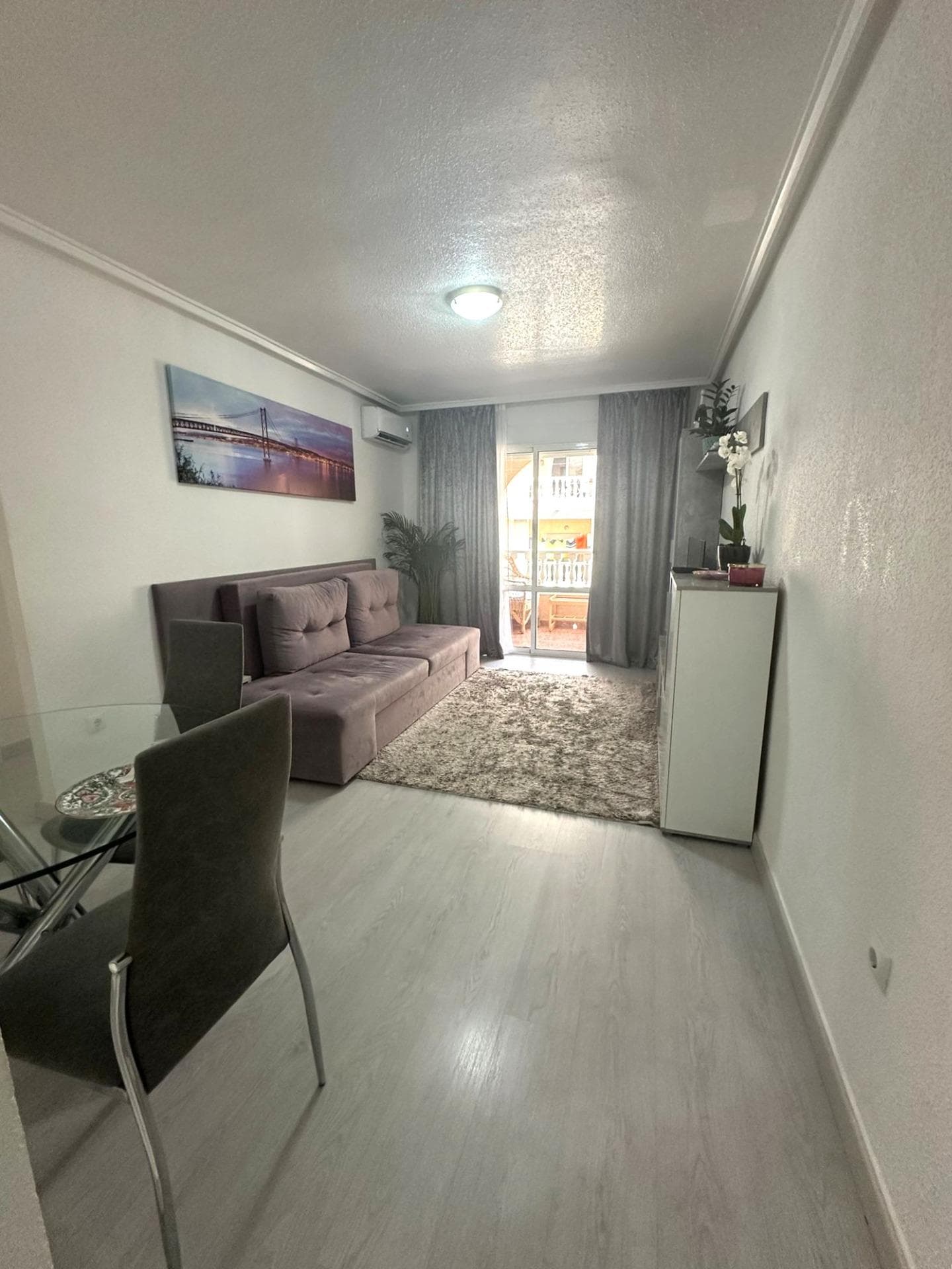 Modern 2 bedroom flat with private terrace, pool and garden in Torrevieja Upon entering this modern refurbished flat, the first thing that strikes you is the natural light that floods every corner. Its south orientation turns the living room into a warm and luminous space throughout the day, ideal to enjoy moments of relax or to spend time with friends. From here, there is direct access to a large private terrace, perfect for having breakfast in the sun, reading a good book or watching the sunset with a glass of wine. The property has two bedrooms. The master bedroom offers a cosy atmosphere, with a built-in wardrobe for extra comfort. The second bedroom, equally bright, is ideal as a guest room, office or children's room. The fully equipped kitchen blends in perfectly with the modern style of the flat, offering a practical and aesthetically pleasing space. The bathroom has been renovated with high quality materials, combining elegance and comfort. But without a doubt, one of the most attractive features of this flat is its surroundings. It is part of a well-kept residential complex with a communal swimming pool and large garden areas, where you can breathe in the tranquillity. An ideal place for those looking for quality of life without giving up the comforts of a modern home. LOCATION: Torrevieja is in the province of Alicante (Costa Blanca). It is famous for its Mediterranean climate and its coast. We cannot forget its promenades where we can find some restaurants along the fine sandy beaches. It also has many excellent beaches such as Playa de los Náufragos (2 km away), Playa de los Locos (2 km away) and Playa de la Mata (4 km away). Therefore, it is considered a remarkable tourist town where the environment takes an important place as an important tourist attraction. In addition, we can find many shopping centres (Habaneras, La Zenia Boulevard), golf courses, sport centres, hospitals (such as Hospital Universitario de Torrevieja) and airports such as Alicante Airport (35 km away) and Region of Murcia International Airport (43 km away). DISTANCE TO THE SEA: 600m COMUNITY: 360 €. IBI: 220 €. Should you have any question do not hesitate to contact us!
