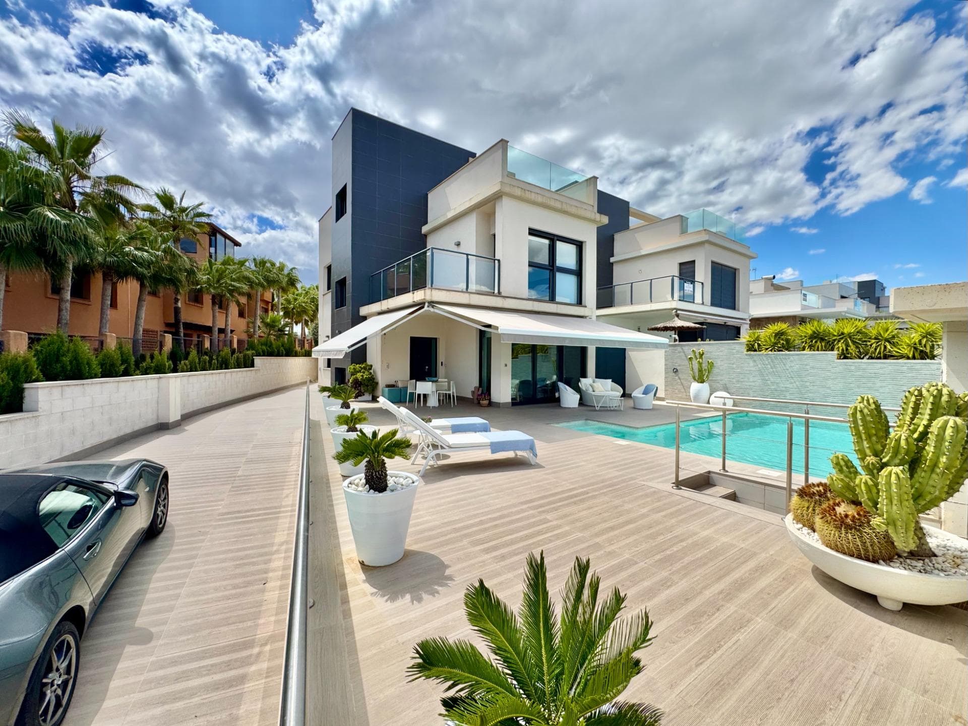exclusive luxury villa set on a generous 350 m² plot with an impressive build size of 250 m², this stunning property perfectly combines space, luxury and comfort. the villa offers 4 spacious bedrooms and 3 elegant bathrooms, with the possibility to create 5 or even 6 bedrooms, making it ideal both as a permanent residence and as an investment with exceptional rental potential. on the ground floor, you are welcomed by a beautiful open-plan living area with an elegant open kitchen that connects seamlessly to the outdoor spaces, creating the perfect indoor-outdoor lifestyle. this level also features one spacious bedroom and one bathroom. on the first floor, there are three additional bedrooms and two stylish bathrooms. one of the bedrooms is the beautiful master suite, featuring its own elegant en-suite bathroom and a private terrace with lovely sea views, creating a peaceful and luxurious retreat within the home. on the top floor, the luxurious solarium with jacuzzi creates the perfect place to relax while enjoying the sun, privacy and open views. the property also benefits from an enormous basement level located underneath the entire house, offering the same surface area as the villa itself. this versatile space can be transformed into a chill-out area, cinema room, gym, entertainment space or additional living area, with the possibility to easily create two extra bedrooms if desired. designed with comfort and quality in mind, the villa features full aerothermal floor heating throughout the entire home and a heated swimming pool for year-round enjoyment. the outdoor areas are equally impressive, with a beautiful front terrace, a spacious back area, generous storage spaces and private parking for multiple cars. every detail of this villa has been carefully designed to combine modern elegance, functionality and a high-end mediterranean lifestyle. a truly stunning property that offers space, luxury and comfort in every corner.