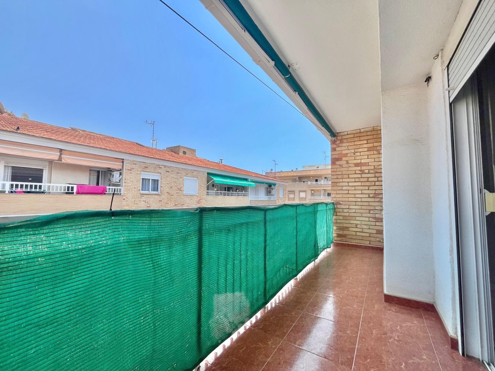 Excellent apartment for sale in Torrevieja, located just 400 meters from the well-known Playa del Cura, one of the city's most iconic beaches. It features a lively promenade, calm waters, and a welcoming atmosphere, ideal for families and visitors all year round. The property is situated on the fourth and top floor of a four-story building, offering plenty of natural light, privacy, and excellent overall condition. Layout:   Three generously sized bedrooms, perfect for rest, family living, or home office use.   One spacious bathroom, comfortable and functional.   Large living and dining area, perfect for entertaining, relaxing, or enjoying family time.   Independent, fully equipped kitchen.   Air conditioning in the living room and ceiling fans in two bedrooms, ensuring comfort throughout the year. Located close to all essential services: supermarkets, restaurants, pharmacies, and public transport. This property is ideal as a permanent home, holiday getaway, or investment for seasonal rental. A fantastic opportunity to live by the sea in one of the most sought-after areas of the Costa Blanca.