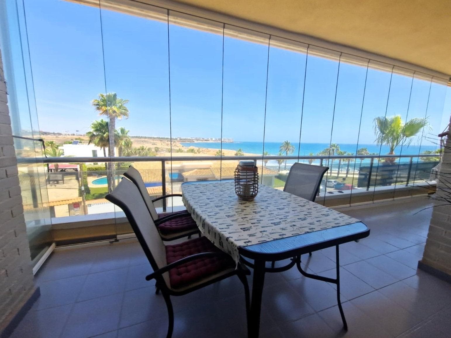With direct sea views, frontline sea front and spacious apartment with community swimming pool and garden, on the beach. It consists of a living room with access to a large terrace with sea views, a fully equipped American kitchen, 2 double bedrooms, 1 single bedroom, 2 bathrooms (one en-suite with the master bedroom), an utility room with a washing machine and shelves for storage and an underground parking space. One of the bedrooms has access to the terrace with sea views. Unfurnished. Built-in wardrobes in the bedrooms. Air conditioning. In very good condition. Communal solarium. The swimming pool and the elevators were refurbished and the façade of the building is going to be renovated. Close to all services, supermarkets, cafés, restaurants, sports facilities, etc.