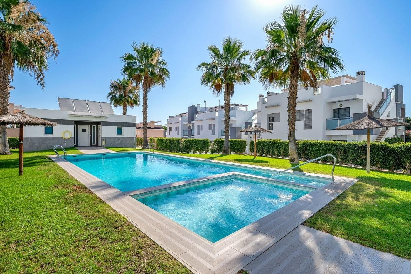 Welcome to this modern penthouse located in a gated and well-kept complex in the heart of Punta Prima, one of the most desirable areas of Torrevieja. Built in 2012, it features two bedrooms with built-in wardrobes, two bathrooms with walk-in showers and elegant finishes, a separate kitchen, bright living room, and two terraces. From the kitchen, a staircase leads to the private rooftop terrace with jacuzzi, dining area, sunbeds, and a pergola for sun or shade. The apartment has ducted air conditioning (hot/cold), is sold furnished, and ready to move in. Parking space included. The complex offers a heated pool, children’s pool, and sauna. Great location: quiet area within walking distance to shops, restaurants, and the sea. Close to indoor padel courts, golf courses, and Zenia Boulevard shopping mall. Alicante Airport is 45 minutes away. Ideal as a holiday home, permanent residence, or rental investment.