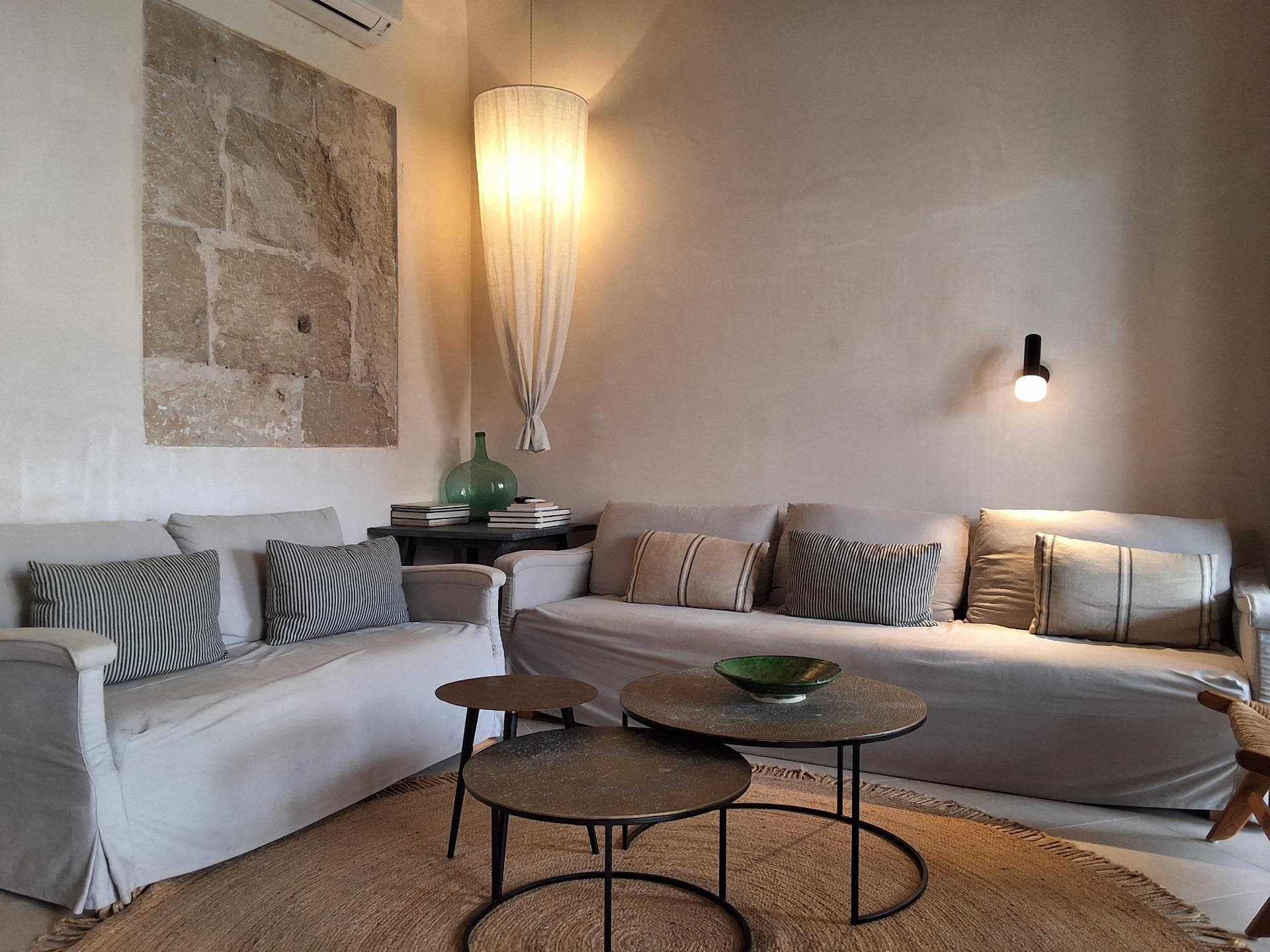 Magnificent 18th-century Mallorcan manor house, fully renovated with all modern amenities. Located in the historic center of Capdepera, on the northeast coast of Mallorca, surrounded by beaches and coves with white sand clear turquoise waters. The house is situated just 50 meters from the town square, with restaurants and cafes offering local and international cuisine, and it boasts views of the medieval Capdepera Castle and the sea.. The residence spans 450 square meters, distributed over two levels, with winter and summer lounges, winter and summer dining rooms, 4 double bedrooms (two with en-suite bathrooms), a full bathroom, a guest toilet, a fully equipped kitchen with appliances, and a laundry and cleaning room. The house features large terraces on both the ground floor and the first floor. From the ground floor, there is access to the garden, pool with solarium and shower, and a barbecue area. It has heating and air conditioning.. Ground floor: Main lounge with fireplace, guest toilet, master bedroom with en-suite bathroom, access to terrace and summer dining area, laundry room, and stairs leading to the upper floor and cellar area. . Mezzanine: Winter dining room and fully furnished kitchen with all appliances (dishwasher, oven, microwave, coffee maker, toaster, blender, and kettle) with views of the garden and Capdepera Castle. The kitchen provides direct access to the summer dining room and terrace. . First floor: 3 double bedrooms with built-in wardrobes (one with en-suite bathroom), a full bathroom, a reading lounge, and access to the upper terrace. . Lower floor: From the main lounge and the kitchen, there is access to the garden with pool, solarium, and barbecue area. The garden also provides access to the summer dressing room, cellar, and games room.. Important: The purchase price does not include taxes associated with the property sale, notary fees, or property registration costs.. We are builders and available for any additional information or to arrange a visit. If you wish to build a new house on this property, please consult us.