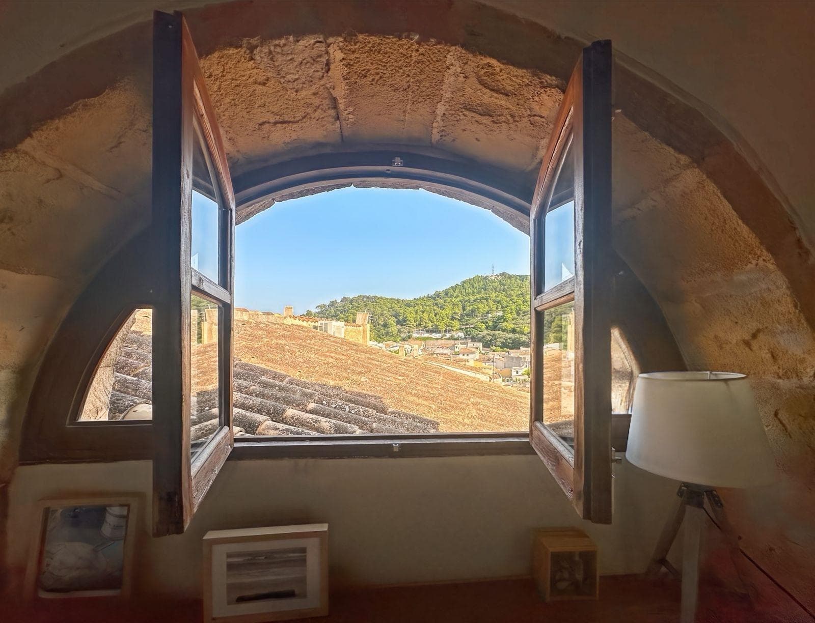 Charming semi-renovated townhouse in the heart of Capdepera’s old town.. Located on one of the most picturesque and iconic streets of Capdepera’s historic centre, next to the famous castle, this 19th-century townhouse has been carefully restored to preserve all its original Mallorcan charm while offering modern comfort and functionality.. The property has a built area of approximately 104 m² distributed over three levels, including a delightful inner courtyard filled with light and greenery – perfect for enjoying pleasant moments outdoors.. On the main floor, the living-dining area with open kitchen provides a warm and bright atmosphere with direct access to the terrace.. The upper floor features an open-plan space ideal as an office, reading corner or multipurpose room, as well as a master bedroom with en-suite bathroom.. The lower floor includes another full bathroom, a second bedroom, and an additional living room with independent access from the street, offering versatility and privacy.. The house retains its original architectural details such as exposed stone walls, wooden beams and traditional floors, combined with a tasteful and high-quality renovation.. Thanks to its privileged location on a quiet, cobbled and central street, just a few minutes from all amenities, this property is ideal as a permanent residence or a holiday retreat.. Important: The price does not include the taxes related to the property purchase, nor the notary and land registry fees.. We are a construction company, so if you need advice on renovations, extensions or any type of project, we will be happy to assist you.