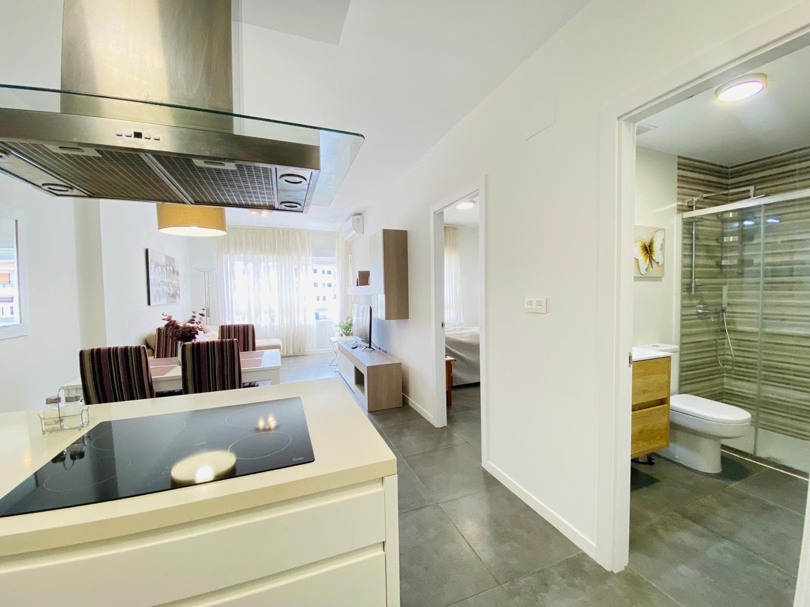 Discover luxury and comfort in this exclusive apartment located in Altos de Campoamor, Orihuela Costa. This modern semi-new space offers a surface area of 47m2 optimized with a contemporary design that highlights its charm. With one double bedroom illuminated by natural light thanks to its southwest orientation, you will enjoy lateral sea views from your own corner balcony or private garden within the urbanization. The equipped kitchen allows you to prepare delights while enjoying the coastal atmosphere. Relax by the community pool during hot summer days or practice sports such as tennis and paddle at facilities available for residents. Strategically located just 800 meters from the Mediterranean Sea and near Zenia Boulevard shopping center, you'll have easy access to essential services like healthcare, pharmacies, and gourmet restaurants. Additionally, it includes a private parking space plus storage room to maximize your daily comfort; live each day surrounded by Mediterranean splendor.