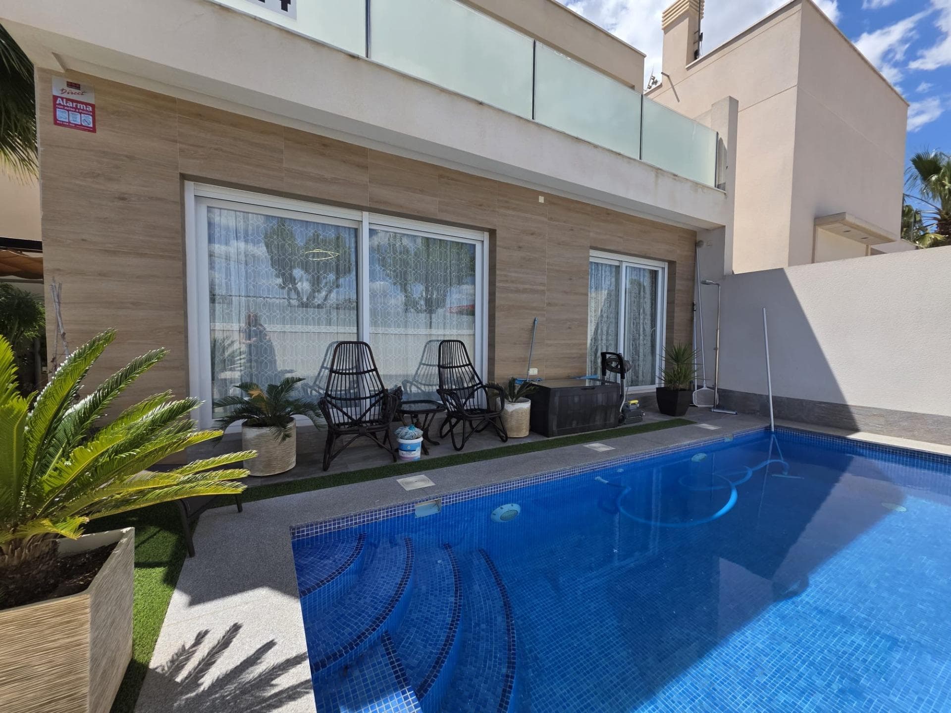 Discover this stunning nearly new villa located in the heart of the charming village of Pilar de la Horadada, just 1500 meters from the sea at Torre Horadada Playa de las Higuericas. This elegant home features a spacious built area of 107 m² and a generous private plot extending over 167 m² with parking access for your car. The property offers two cozy double bedrooms and an additional single room, complemented by two full bathrooms and an extra toilet for added convenience. Equipped with a fully fitted modern kitchen and premium amenities such as heating/cooling air conditioning, centralized heating, and alarm systems for your security. Refined details include white lacquered interior carpentry, stylish ceramic floors, and Climalit windows that ensure energy efficiency. The exterior is equally captivating: relax by your own private pool or host unforgettable barbecues under a wooden pergola or beneath the stars while enjoying unobstructed views from your personal terrace surrounded by beautiful well-maintained gardens. This privileged location places you close to Torre Horadada beaches & Mil Plameras paradises along with endless local services like shopping centers; hospitals; schools; universities & playgrounds ; golf courses .... This villa represents more than simply living; it’s about indulging every day amidst tranquil luxury! Don’t miss out on this unique opportunity!
