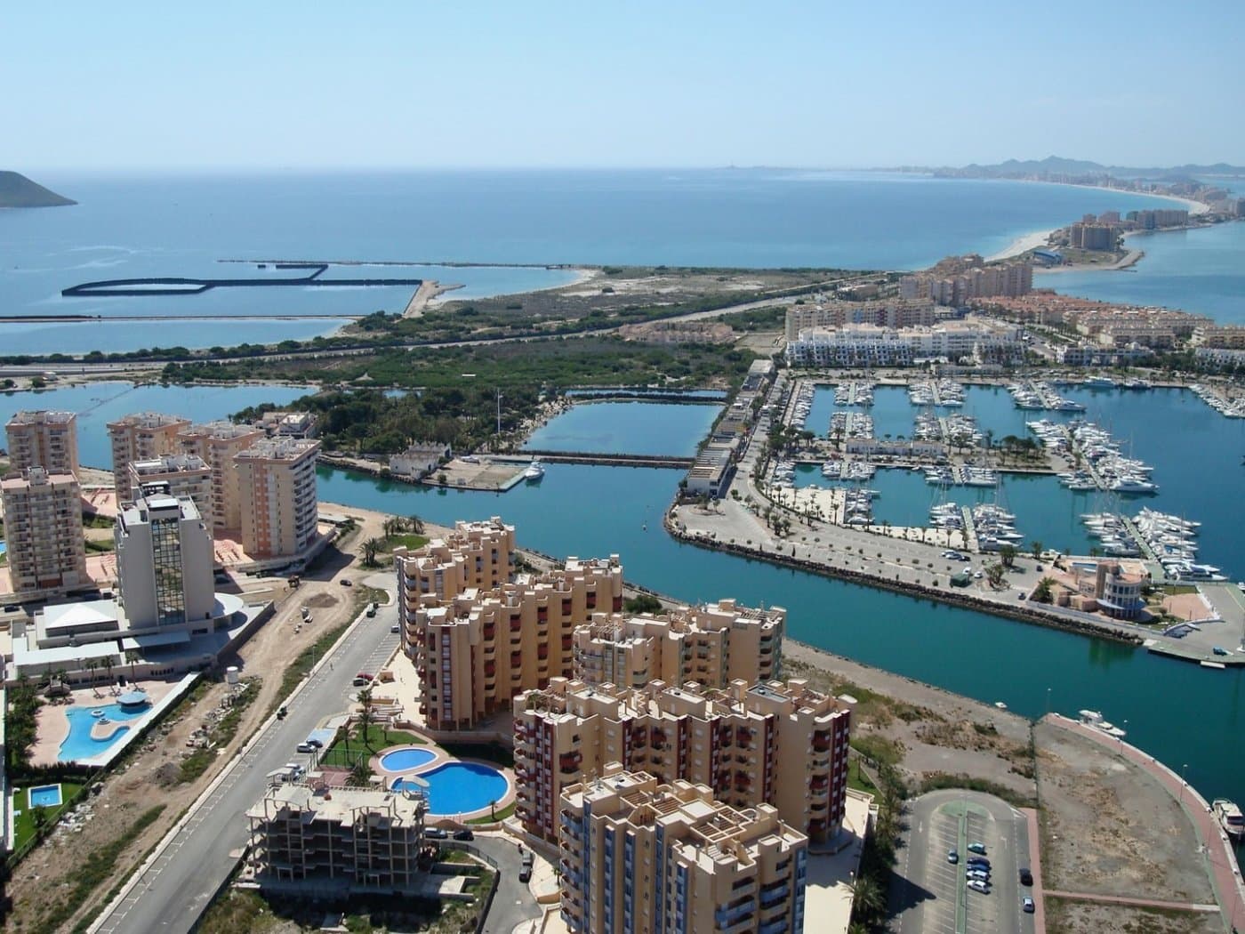 HERMOSOS APARTAMENTOS CON VISTAS AL MAR EN LA MANGA&#13;&#13; Esta urbanización está ubicada en la zona de mayor expansión de La Manga.&#13; En esta nueva urbanización las viviendas han sido diseñadas para aprovechar cada rincón de la casa, así como el cuidado en la elección de los materiales y su diseño.&#13; Apartamentos con puerta de entrada blindada y puertas lacadas en blanco con herrajes de acero inoxidable.&#13; Persianas blancas, monobloque y doble acristalamiento con cámara de aire.&#13; En el dormitorio principal armario empotrado con puertas correderas, con balda separadora en el entrepiso, barra y cómoda de tres cajones.&#13; Cocina con mueble alto y bajo, en color blanco, tirador tipo gola, fregadero 1 seno con escurridor, vitrocerámica, horno eléctrico y campana extractora.&#13; Preinstalación de aire acondicionado (frío y calor) mediante conductos con provisión de zonificación de estancias.&#13;&#13; La Manga del Mar Menor es una franja de tierra natural rodeada por dos mares, el Mar Menor y el Mar Mediterráneo. A esta rareza se le suman las múltiples opciones de ocio y tiempo libre, restaurantes, supermercados, centros médicos, farmacias, polideportivos náuticos, campos de golf.&#13; La Manga se encuentra en la costa norte de la Costa Cálida y es un destino de vacaciones popular para los turistas. La estrecha franja de tierra que separa la laguna cálida y el mar más frío tiene un microclima único. Es una de las zonas más exóticas de España.&#13; El aeropuerto de Corvera está a aproximadamente 1 hora en coche y el aeropuerto de Alicante a unas 2 horas.&#13;