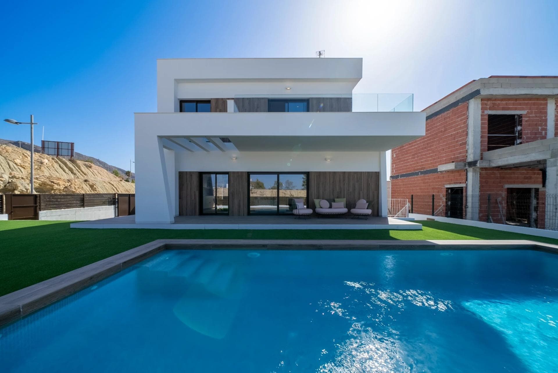 NEW BUILD VILLAS IN FINESTRAT

Residential of modern villas has been meticulously designed to capture the beauty of Sierra Cortina and the Mediterranean in every corner. 

Villas build over 2 floors and has 3 bedrooms, 3 bathrooms, open plan kitchen with lounge, build-in wardrobes, equipped kitchen, private garden with the pool and parking.

Residential located ​next to two golf courses, theme parks, a large shopping centre and a few minutes from the beaches of Benidorm

Finestrat located in the Marina Baixa region of the Costa Blanca, close to neighbouring Benidorm and about 40 kilometres from the city of Alicante and the international airport.

Benidorm is just a five-minute drive from the properties and offers all the services you would need including shops, bars, restaurants, supermarkets, banks, pharmacies and several private international schools.

Close to the beaches of Levante, Poniente and Cala de Finestrat, with more than 6km in length that are among the best in Europe awarded by the European Union with Blue Flags.

All leisure services such as the theme parks of Aqua Natura, Terra Mítica, Terra Natura, Aqualandia and Mundomar, Sierra Cortina and Villaitana Golf courses, hiking and climbing in Puig Campana an incomparable natural setting or enjoy of nautical sports.