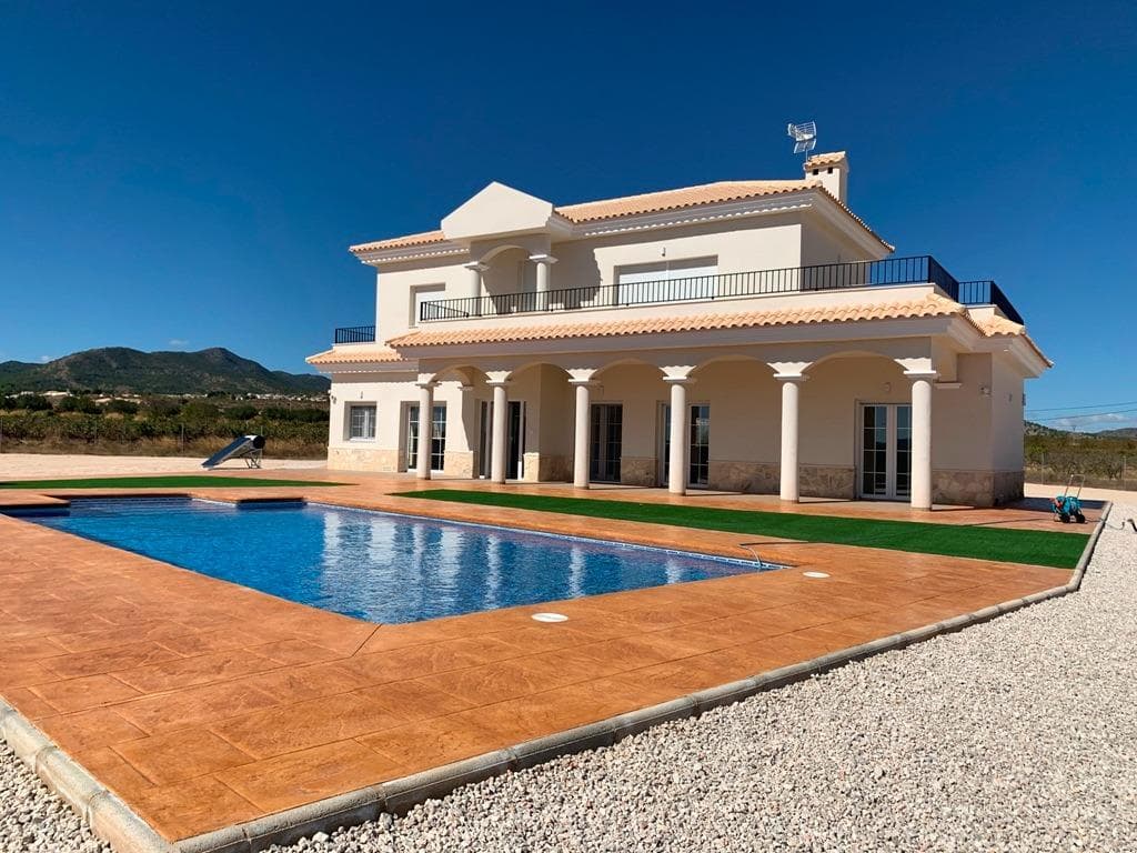 NEW BUILD VILLAS IN PINOSO

You can choose Villas with traditional Spanish touches or super modern finishing, bright and clean. 
Different legal building plots available (rustic with minimum 10.000 m2), some walking distance to town, some totally private and our most popular ones are within 5-10 mins drive to a town. 
We have a plot for every taste, all with amazing views and all have mains water + electric included in the price and high speed internet available. 
From the biggest and best builder in the area and use top quality materials for a perfect finish. 
All houses include 2m stamped concrete terrace around the pool (colour and pattern to choose), 1m around the house, gated entrance, 3.000 m2 fencing, pre-installed ducted aircon, standard kitchen, security door, german tilt and turn windows (or sliding if prefered), built-in fireplace and chimney, pre-installation for tv and internet, gravel driveway plus a few meters around the house, septic tank. 
Bathrooms include a shower column, shower tray or bath, sink units (various colours to choose from) with sinks, taps and mirrors, plus a big selection of wall tiles. 
Wide selection of ceramic floor tiles, different colours, wood effect, etc. 
Kitchens include cabinets with standard doors and handles, as per plans provided, stainless steel sink and tap, pre-installation for oven, dishwasher, extractor. Various granite worktops to choose from included in the budget, other stone worktops available as extras. White goods not included. 
Marble staircase (cream, white, or grey) and railings included, plus railings for the front porch. 
Big fixed glass window on the staircase for extra light. 
Choice of tiles and steps design for swimming pool. Choice of the granite for the houses' exterior steps and window sils. 
You can customise the house to suit, most internal changes are free of charge, the houses can be extended and we can even build your own design. 
Upgrade to bigger pool, single or double garage, guest house, etc. at an extra cost.

The beautiful and thriving town of Pinoso is approximately 45 minutes inland from Alicante and the white beaches of Costa Blanca and close to the Murcia, Alicante border

It has a population of just under 8,000. Pinoso, also known as El Pinos is named after the pine trees that cover the areas mountain ranges. Pinoso provides a Spanish rural lifestyle, no traffic lights, hardly any traffic, practically the only jams are caused by the tractors taking the grapes to the Bodega. The fields are planted with vines, almonds and olives. In February the fields are filled with pink almond blossom.

Pinoso has many bars, restaurants and shops, a new 24 hour medical centre, dentists, two primary schools and 1 secondary school, a theatre. There's an excellent Sports Centre with outdoor swimming pools, tennis courts, football pitches and gymnasium, library and many other facilities including a beautiful picnic area among the pines, complete with barbecues, seating areas and running water.