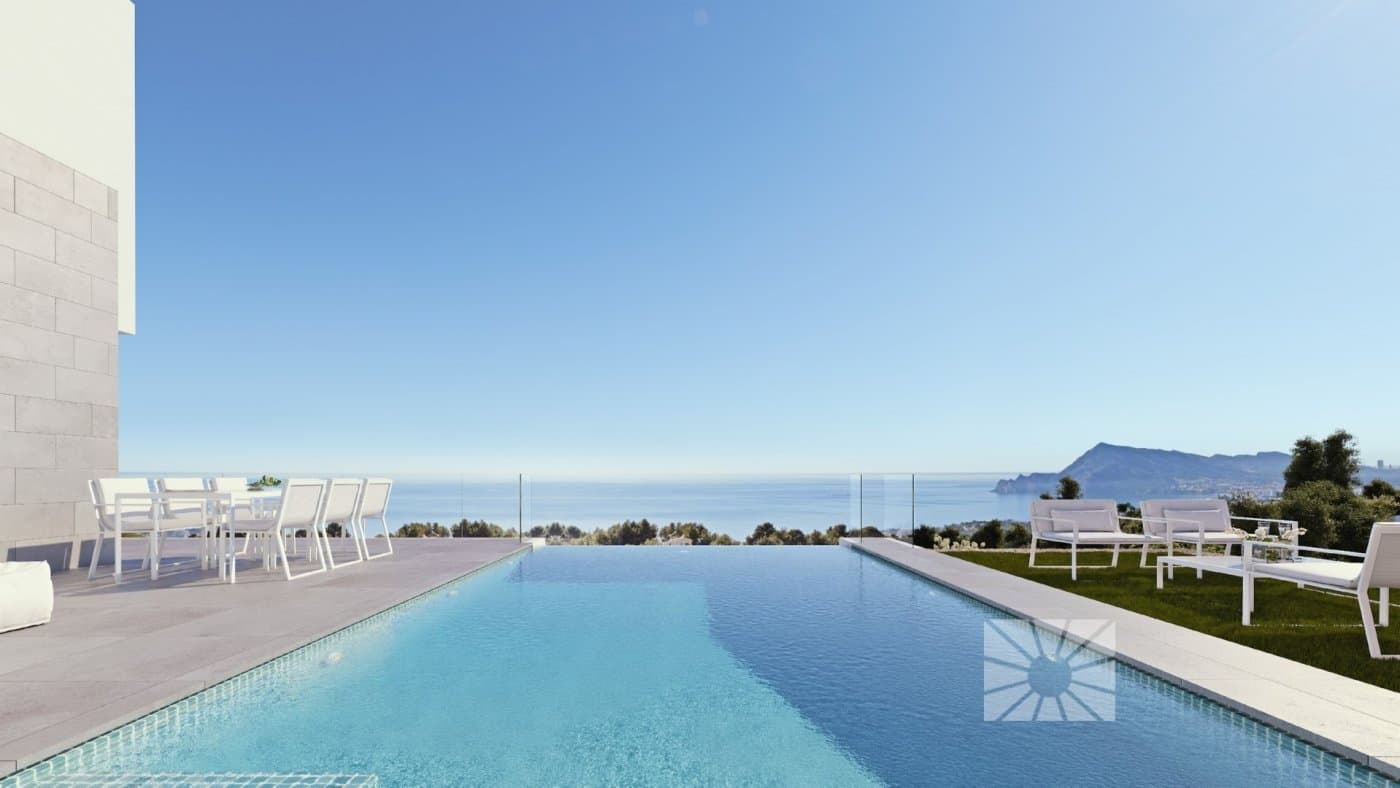 LUXURY VILLA WITH STUNNING SEA VIEWS

 On Sierra de Altea, with impressive sea views, we come across this minimalist style brand new villa, with the best quality and a perfect design.

 Villa is distributed over 3 floors, the top floor has a garage for two cars and an entrance hall that allows us to access the rest of the property. On the middle floor there are three of the four bedrooms of this house, two main bedrooms and two additional bedrooms. The main bedroom located on this floor has the perfect position to soak up the wonderful sea views, it has access to a private terrace and it has an en-suite bathroom as well as a walk-in closet. The other two bedroom also each have their own en-suite bathrooms, spacious wardrobes and they share a terrace. There are also extra cupboards in the corridor that leads up to the bedrooms.

 The main floor is distributed in two areas, separated by a hall and the stairwell. On one side is the fourth bedroom with its en-suite bathroom, walk-in closet and access to the main terrace with a porch area. The other side is where you can find a guest toilet, a kitchen which is open to the dining room, with a centre island, on this centre island is the cooking area and a lovely place to have breakfast, the dining room with direct access to the porch and a bright living room. Three open spaces, resplendent with natural light from the Mediterranean and, more importantly, connected with the exterior of the property, with several porches, an outside guest toilet, a large terrace and a swimming pool. The swimming pool has an endless side so you don´t miss the sea views for even a second. 

 Villa is equipped with a lift, a security system, under-floor heating, air-conditioning, technical lighting and garden areas. Design, fixtures and fittings, quality and wonderful sea views sum up this villa that is waiting for you in Altea, North Costa Blanca.