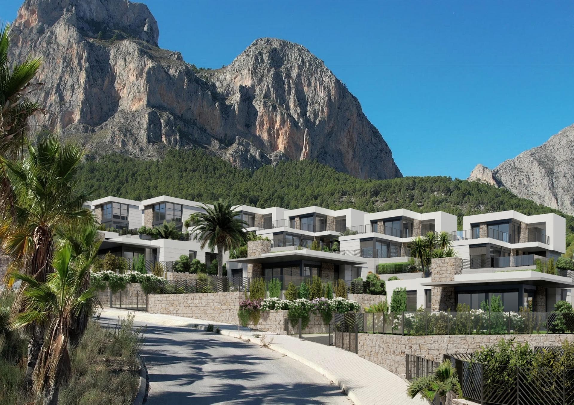 New Construction Villas in Polop, Alicante

Modern Living Surrounded by Nature
Discover this exclusive residential development of newly built villas in Polop, a charming inland village located in the province of Alicante. Just 10 km from Benidorm’s lively beaches and nightlife and close to the picturesque town of Altea, these homes offer an unbeatable combination of modern comfort and natural beauty.

A Residential Development Tailored to Your Needs
The project consists of 65 independent villas available in different layouts to suit your needs and budget. Choose between 3 or 4-bedroom homes, with options for single or two-story designs. Many of the properties are designed on a single level, providing enhanced accessibility and a comfortable living experience without the need for stairs.

Each home is thoughtfully designed with spacious terraces, private gardens, and interior/exterior spaces where you can enjoy the Mediterranean climate. Optional private pools are also available to add an extra touch of luxury to your new home.

Prime Location with Easy Access to Key Destinations
Located in a peaceful natural setting, the development is ideal for those seeking tranquility without sacrificing convenience. The surrounding area offers access to key points of interest:

Benidorm Beaches: 10 km (15-minute drive)
Playa del Albir: 12 km (20 minutes), renowned for its pristine waters and scenic promenade
Alicante Airport: 60 km (45 minutes)
Villaitana Golf Course: 12 km (15 minutes)
La Marina Shopping Center: 10 km (15 minutes)

Premium Features for Modern Comfort
Each villa is equipped with high-quality finishes and state-of-the-art systems, ensuring maximum comfort, security, and sustainability:
Double-glazed PVC windows with thermal and solar insulation
Reinforced front doors for enhanced security
Fully equipped kitchens with induction hob, oven, extractor hood, and stainless-steel sink
Modern bathrooms with stylish porcelain sinks and fittings
Pre-installed ducted air conditioning with heat pump
Hot water supplied via aerothermal systems for energy efficiency
Gated community with perimeter surveillance cameras

Polop: The Perfect Blend of History and Nature
Polop de la Marina is a historic town surrounded by stunning landscapes. Its charming old town, the Gabriel Miró House-Museum, and various hiking trails make it a sought-after destination for nature and history enthusiasts.

Experience Coastal and Countryside Living
Embrace a new lifestyle in these carefully designed homes, where comfort meets nature. Enjoy the panoramic views through large windows that frame the surrounding landscape, creating the perfect balance between indoor and outdoor living.

Don’t miss the opportunity to own your dream home in Polop! Contact us today for more information and to schedule a visit.