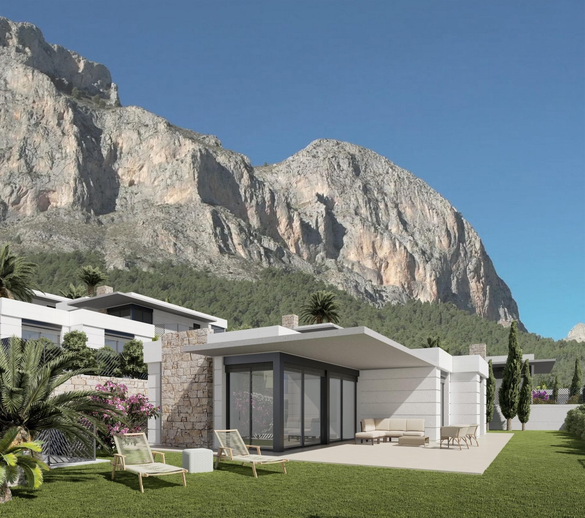 New Construction Villas in Polop, Alicante

Modern Living Surrounded by Nature
Discover this exclusive residential development of newly built villas in Polop, a charming inland village located in the province of Alicante. Just 10 km from Benidorm’s lively beaches and nightlife and close to the picturesque town of Altea, these homes offer an unbeatable combination of modern comfort and natural beauty.

A Residential Development Tailored to Your Needs
The project consists of 65 independent villas available in different layouts to suit your needs and budget. Choose between 3 or 4-bedroom homes, with options for single or two-story designs. Many of the properties are designed on a single level, providing enhanced accessibility and a comfortable living experience without the need for stairs.

Each home is thoughtfully designed with spacious terraces, private gardens, and interior/exterior spaces where you can enjoy the Mediterranean climate. Optional private pools are also available to add an extra touch of luxury to your new home.

Prime Location with Easy Access to Key Destinations
Located in a peaceful natural setting, the development is ideal for those seeking tranquility without sacrificing convenience. The surrounding area offers access to key points of interest:

Benidorm Beaches: 10 km (15-minute drive)
Playa del Albir: 12 km (20 minutes), renowned for its pristine waters and scenic promenade
Alicante Airport: 60 km (45 minutes)
Villaitana Golf Course: 12 km (15 minutes)
La Marina Shopping Center: 10 km (15 minutes)

Premium Features for Modern Comfort
Each villa is equipped with high-quality finishes and state-of-the-art systems, ensuring maximum comfort, security, and sustainability:
Double-glazed PVC windows with thermal and solar insulation
Reinforced front doors for enhanced security
Fully equipped kitchens with induction hob, oven, extractor hood, and stainless-steel sink
Modern bathrooms with stylish porcelain sinks and fittings
Pre-installed ducted air conditioning with heat pump
Hot water supplied via aerothermal systems for energy efficiency
Gated community with perimeter surveillance cameras

Polop: The Perfect Blend of History and Nature
Polop de la Marina is a historic town surrounded by stunning landscapes. Its charming old town, the Gabriel Miró House-Museum, and various hiking trails make it a sought-after destination for nature and history enthusiasts.

Experience Coastal and Countryside Living
Embrace a new lifestyle in these carefully designed homes, where comfort meets nature. Enjoy the panoramic views through large windows that frame the surrounding landscape, creating the perfect balance between indoor and outdoor living.

Don’t miss the opportunity to own your dream home in Polop! Contact us today for more information and to schedule a visit.