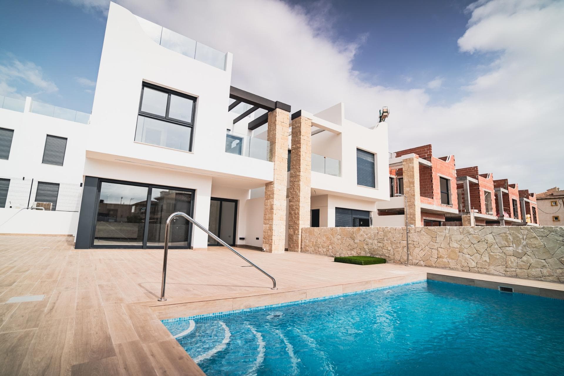 New Build Bungalows and Villas in Pilar de la Horadada

Modern Homes Near the Beach
Discover this exclusive new residential complex in Pilar de la Horadada, offering bungalows and villas just 2 km from the beach. Designed for comfort and style, these homes provide an excellent opportunity to enjoy life on the Costa Blanca.

Spacious and Stylish Properties
This development offers 2, 3, or 4-bedroom homes with 2 or 3 bathrooms and private parking. Choose from:
Ground-floor bungalows with a private garden.
Top-floor bungalows featuring a private solarium.
Independent villas with a private pool.

Each property is built with high-quality materials and modern finishes, including:
Ducted air conditioning pre-installation.
Aluminum exterior carpentry, double glazing, and injected aluminum shutters.
Security entrance door for added peace of mind.
Aerothermal system for efficient hot water production.
Built-in wardrobes in bedrooms.
Fully equipped bathrooms with furniture and shower screens.

Exclusive Community Features
This private residential complex boasts a beautiful communal pool and landscaped gardens, creating an ideal space for relaxation. Located just outside the town center, residents can walk to supermarkets, restaurants, bars, schools, and other essential services.

Prime Location in Pilar de la Horadada
Pilar de la Horadada is a charming Spanish town in the southernmost part of the Costa Blanca. It offers a vibrant main street with numerous shops, supermarkets, restaurants, and picturesque squares.

The stunning beaches of Torre de la Horadada and Mil Palmeras are only 5 minutes away, featuring fine golden sand a scenic promenade. The town also offers well-developed cycling paths and walking trails, along with a variety of sports activities.

Convenient Access to Key Destinations
Lo Romero Golf Course – 5 km (10-minute drive).
Corvera Airport (Murcia) – 40 km (40-minute drive).
Alicante Airport – 55 km (55-minute drive).
Shopping Centers (La Zenia Boulevard) – 15 km (15-minute drive).
Torre de la Horadada Marina – 3 km (5-minute drive).

Secure Your Dream Home Today
Don't miss this fantastic opportunity to own a brand-new home in a prime location. Contact us today for more information and to arrange a visit!