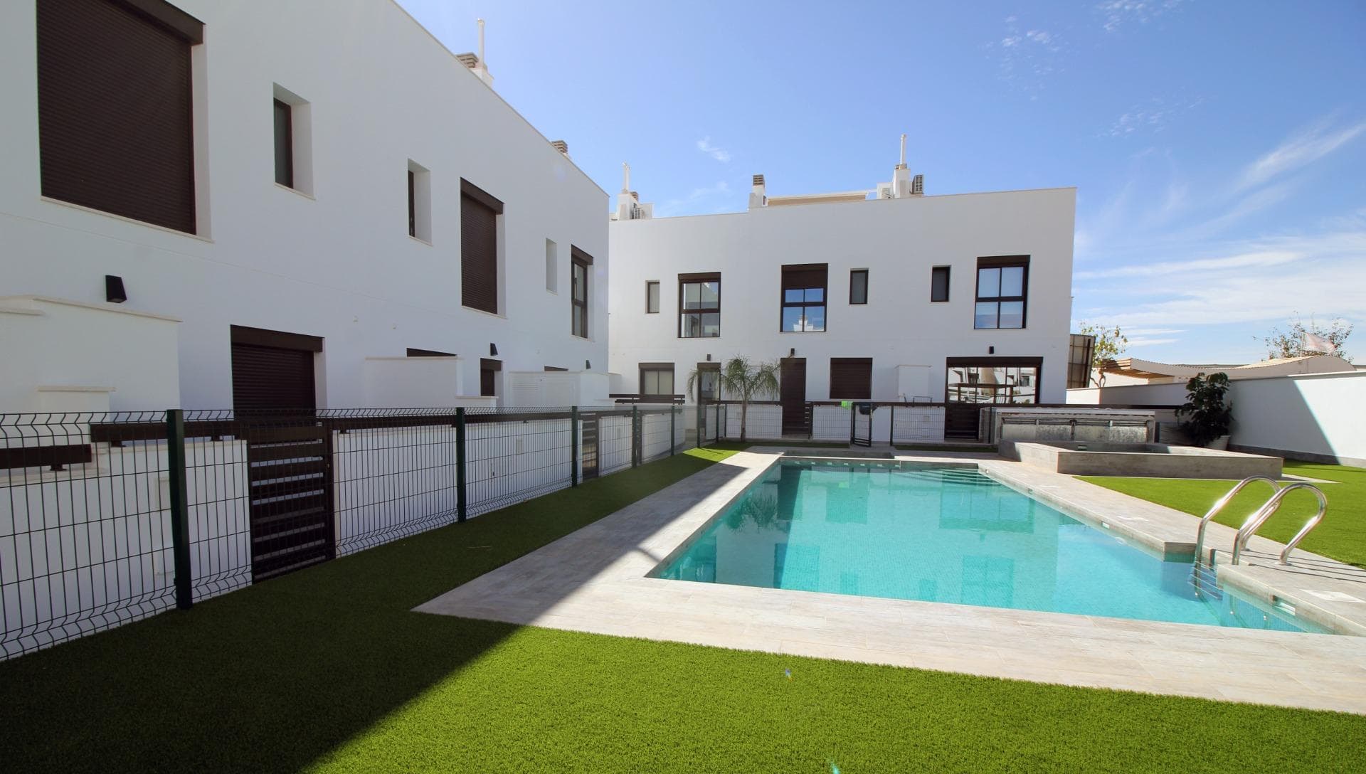 Modern Townhouses and Semi-Detached Homes in Pilar de la Horadada

Discover this exclusive residential development featuring only six modern semi-detached and terraced homes in the tranquil town of Pilar de la Horadada, on the southern tip of the Costa Blanca. Designed with contemporary architecture and high-quality finishes, these new-build properties offer a perfect blend of comfort and style in a sought-after location.

Spacious Three and Four Bedroom Layouts

Each home boasts spacious living areas with an open-plan kitchen and living room designed to maximise natural light. Choose from three or four-bedroom floor plans, with two or three bathrooms depending on the model. Ground-floor layouts include two terraces: a front terrace with space for private parking and a rear terrace with direct access to the communal pool. The first floor features an additional terrace off the bedrooms, while upstairs a rooftop solarium provides panoramic views and an ideal space for outdoor entertaining.

High-Quality Interior Finishes

Interiors are appointed with premium materials, including smooth plaster walls, porcelain tile flooring throughout, and fitted wardrobes in each bedroom. The open kitchens come fully equipped with modern cabinetry. Additional comforts include pre-installation for ducted air conditioning and aerothermal systems for energy-efficient hot water.

Community Amenities and Private Parking

Residents enjoy a well-maintained communal pool, perfect for relaxation on sunny days. Each home includes a private on-plot parking space, ensuring security and convenience.

Pilar de la Horadada: Traditional Charm on the Costa Blanca

Pilar de la Horadada is a charming Spanish town known for its welcoming atmosphere and traditional architecture. The town centre is just a short walk away, where you will find supermarkets, local shops, restaurants, bars, and picturesque plazas. Enjoy a leisurely stroll along the main street, sampling authentic Mediterranean cuisine or exploring artisan boutiques.

Proximity to Beaches and Airports

Experience the best of coastal living with the fine sandy beaches of Torre de la Horadada and Mil Palmeras just a 5‑minute drive (approximately 2 km) from your new home. These beaches boast clear waters, golden sand, and a lively promenade lined with cafés and sea-view restaurants.

For easy travel, Corvera Airport (Murcia) is approximately 40 km away (40 minutes by car), and Alicante Airport is around 55 km (55 minutes by car). Additionally, La Zenia Boulevard shopping centre is 15 km (15 minutes) from the development, offering a wide range of retail, dining, and entertainment options.

Secure Your New Home Today

Don’t miss this opportunity to own a brand-new semi-detached or terraced home in Pilar de la Horadada. Combining modern design, top-quality finishes, and a prime location near beaches, shops, and services, these properties are ideal as a permanent residence, holiday home, or investment. Contact us now for more information and to arrange a visit.
