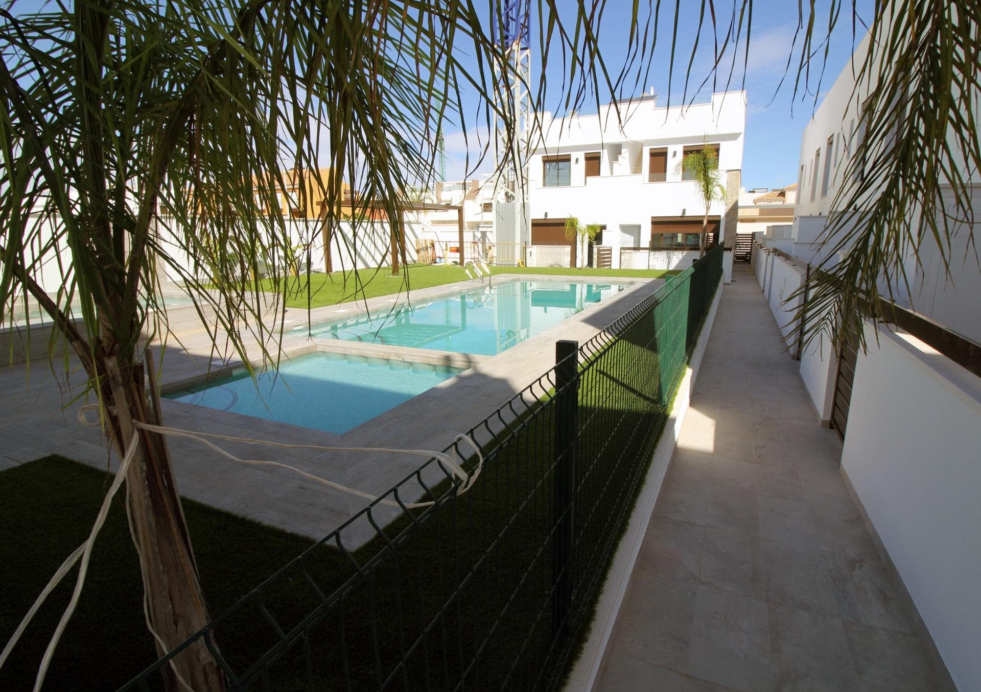 Modern Townhouses and Semi-Detached Homes in Pilar de la Horadada

Discover this exclusive residential development featuring only six modern semi-detached and terraced homes in the tranquil town of Pilar de la Horadada, on the southern tip of the Costa Blanca. Designed with contemporary architecture and high-quality finishes, these new-build properties offer a perfect blend of comfort and style in a sought-after location.

Spacious Three and Four Bedroom Layouts

Each home boasts spacious living areas with an open-plan kitchen and living room designed to maximise natural light. Choose from three or four-bedroom floor plans, with two or three bathrooms depending on the model. Ground-floor layouts include two terraces: a front terrace with space for private parking and a rear terrace with direct access to the communal pool. The first floor features an additional terrace off the bedrooms, while upstairs a rooftop solarium provides panoramic views and an ideal space for outdoor entertaining.

High-Quality Interior Finishes

Interiors are appointed with premium materials, including smooth plaster walls, porcelain tile flooring throughout, and fitted wardrobes in each bedroom. The open kitchens come fully equipped with modern cabinetry. Additional comforts include pre-installation for ducted air conditioning and aerothermal systems for energy-efficient hot water.

Community Amenities and Private Parking

Residents enjoy a well-maintained communal pool, perfect for relaxation on sunny days. Each home includes a private on-plot parking space, ensuring security and convenience.

Pilar de la Horadada: Traditional Charm on the Costa Blanca

Pilar de la Horadada is a charming Spanish town known for its welcoming atmosphere and traditional architecture. The town centre is just a short walk away, where you will find supermarkets, local shops, restaurants, bars, and picturesque plazas. Enjoy a leisurely stroll along the main street, sampling authentic Mediterranean cuisine or exploring artisan boutiques.

Proximity to Beaches and Airports

Experience the best of coastal living with the fine sandy beaches of Torre de la Horadada and Mil Palmeras just a 5‑minute drive (approximately 2 km) from your new home. These beaches boast clear waters, golden sand, and a lively promenade lined with cafés and sea-view restaurants.

For easy travel, Corvera Airport (Murcia) is approximately 40 km away (40 minutes by car), and Alicante Airport is around 55 km (55 minutes by car). Additionally, La Zenia Boulevard shopping centre is 15 km (15 minutes) from the development, offering a wide range of retail, dining, and entertainment options.

Secure Your New Home Today

Don’t miss this opportunity to own a brand-new semi-detached or terraced home in Pilar de la Horadada. Combining modern design, top-quality finishes, and a prime location near beaches, shops, and services, these properties are ideal as a permanent residence, holiday home, or investment. Contact us now for more information and to arrange a visit.