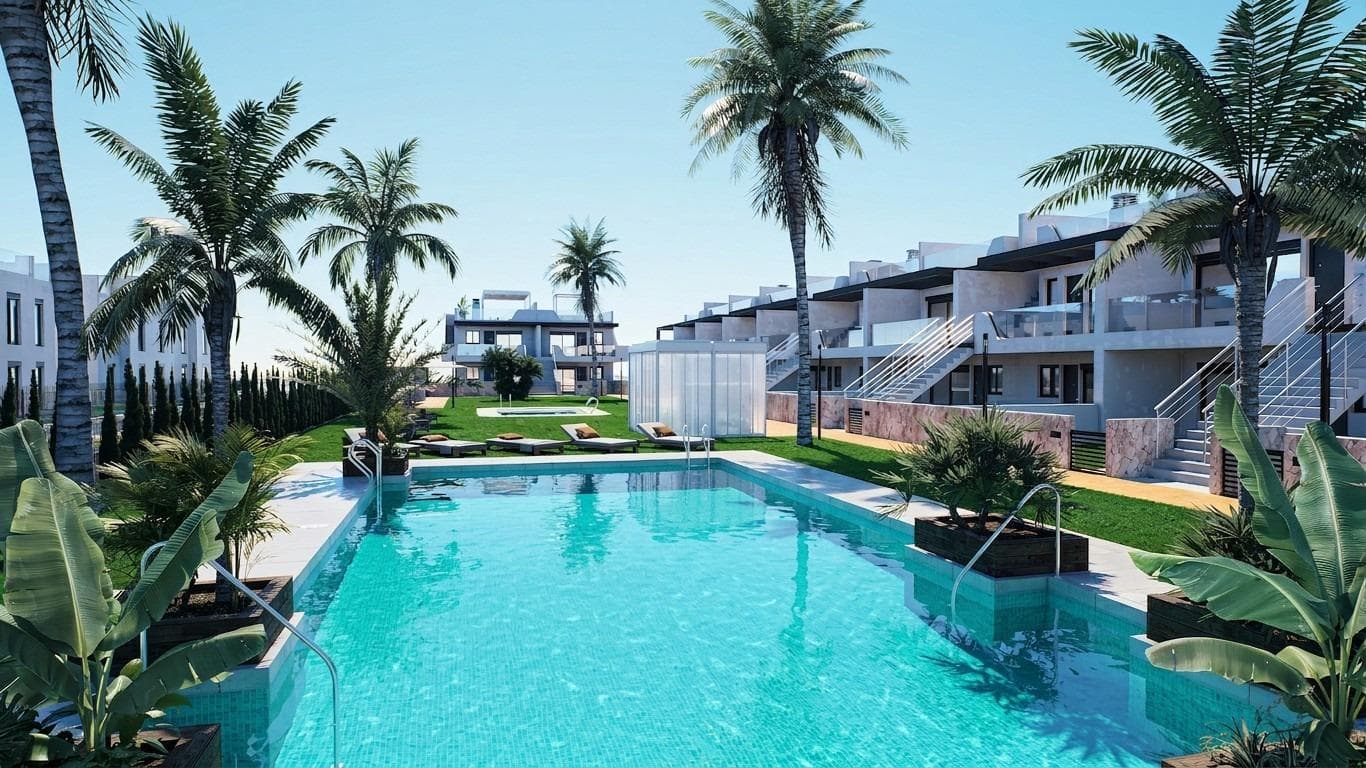 New Build Bungalows with Garden or Solarium Near the Beach in Pilar de la HoradadaModern Mediterranean Homes Designed for ComfortDiscover this exclusive new build residential complex in Pilar de la Horadada, offering contemporary bungalows located less than 2 km from the beach. Designed to combine comfort, style and functionality, these homes are ideal for year round living, holidays or as a smart investment on the Costa Blanca.The development offers a choice between ground floor bungalows with private gardens and top floor bungalows with private rooftop solariums. Each property is thoughtfully designed to maximize outdoor living and make the most of the Mediterranean climate.Spacious 2 Bedroom Properties with High Quality FinishesEach bungalow features 2 bedrooms and 2 bathrooms, one of them ensuite, along with a private parking space in the underground garage. The homes are built with quality materials and modern finishes that ensure energy efficiency and durability.Key features include:Preinstallation for ducted air conditioningAluminium exterior carpentry with double glazing and motorized shuttersSecurity entrance door for peace of mindAerothermal system for efficient hot water productionBuilt in wardrobes in all bedroomsFully equipped bathrooms with furniture and shower screensThese specifications provide a comfortable and practical home suitable for all seasons.Private Community with Pool and Landscaped GardensThe residential complex is private and secure, with beautifully landscaped communal gardens and a large communal swimming pool. This creates a pleasant and relaxing environment where residents can unwind and enjoy the excellent climate.Located just outside the town center, the development allows residents to walk to supermarkets, restaurants, bars, schools and essential services without needing a car.Excellent Location Close to Beaches and ServicesPilar de la Horadada is a charming Spanish town in the southernmost part of the Costa Blanca, known for its lively atmosphere, local shops, traditional squares and friendly community.The sandy beaches of Torre de la Horadada Beach and Mil Palmeras Beach are just 2 km away, offering fine golden sand, a scenic promenade and a marina. The area is also ideal for cycling, walking and outdoor sports.Distances to Key Points of InterestLo Romero Golf 5 kmLa Zenia Boulevard 15 kmMurcia Corvera Airport 40 kmAlicante Airport 55 kmTorre de la Horadada Marina 3 kmReserve Your New Home TodayDo not miss this opportunity to own a brand new bungalow near the beach in one of the most desirable areas of the Costa Blanca. Contact us today for more information and to arrange a visit.