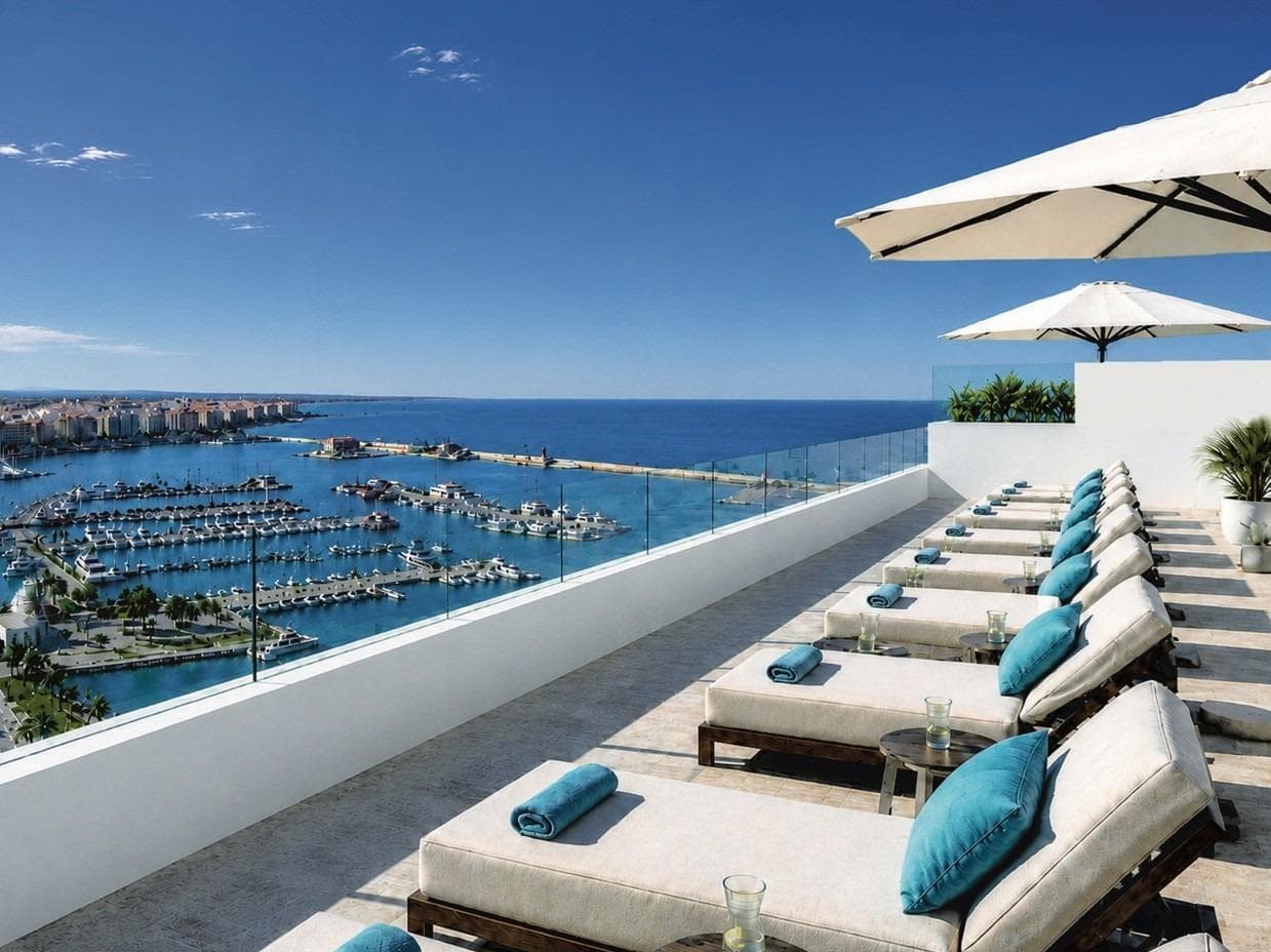 Luxury New Build Apartments Near Torrevieja Marina and Playa del CuraExclusive Apartments in the Heart of TorreviejaDiscover this elegant new residential development of just 23 luxury apartments located in one of the most desirable areas of Torrevieja, only 100 meters from the marina promenade and 400 meters from Playa del Cura. Perfectly positioned in the vibrant city center, this boutique building offers modern Mediterranean living surrounded by restaurants, shops, supermarkets, cafés and all essential daily services within walking distance.Torrevieja is one of the most popular destinations on the Costa Blanca, famous for its year round sunshine, lively atmosphere, beautiful beaches and excellent infrastructure. With an average annual temperature of 20 degrees, the city offers an exceptional quality of life for both permanent residents and holiday homeowners.Modern Apartments with Contemporary DesignThis exclusive development consists of 23 contemporary apartments distributed over four residential floors above a commercial ground floor. Buyers can choose between stylish 1 and 2 bedroom layouts, carefully designed to maximize natural light, comfort and functionality.The homes feature open plan living and dining areas connected to modern American style kitchens, creating bright and spacious interiors ideal for modern lifestyles. Terraces extend the living spaces outdoors, allowing residents to enjoy the Mediterranean climate throughout the year.The project also includes 5 exclusive penthouses with private solariums and private swimming pools, offering panoramic views and an exceptional outdoor living experience.Premium Features and Communal AreasThe building has been designed with high quality materials and modern specifications to ensure comfort, energy efficiency and elegance. Most apartments include a private underground parking space and storage room.Residents can enjoy a beautiful rooftop communal swimming pool with solarium area and sea views, easily accessible by lift. This private rooftop space provides the perfect setting to relax and enjoy the Costa Blanca sunshine.Additional features include:Reinforced security entrance doorBathrooms with furniture, shower screens and underfloor heatingExterior carpentry with thermal break and double glazingPre installation for ducted air conditioningModern fitted kitchens and contemporary finishes throughoutPrime Location Close to Beaches and ServicesTorrevieja offers an exceptional coastal lifestyle with sandy beaches, marina facilities, waterfront restaurants and natural surroundings. The famous Natural Park of La Mata and Torrevieja, known for its pink salt lagoons and walking trails, is only a short drive away.Distances to key points of interest:Playa del Cura: 0.4 kmTorrevieja Marina: 0.2 kmNew Port Commercial Area: 0.2 kmLa Mata Natural Park: 4 kmVillamartin Golf: 8 kmLa Zenia Boulevard Shopping Centre: 10 kmAlicante Airport: 45 kmMurcia Corvera Airport: 60 kmSecure Your New Home on the Costa BlancaThis exclusive new development combines luxury, location and lifestyle in the center of Torrevieja. Whether you are looking for a permanent residence, holiday apartment or investment opportunity, these modern homes offer outstanding value in one of the Costa Blanca’s most attractive coastal cities.Contact us today for more information or to arrange a private viewing of these exceptional new build apartments in Torrevieja.