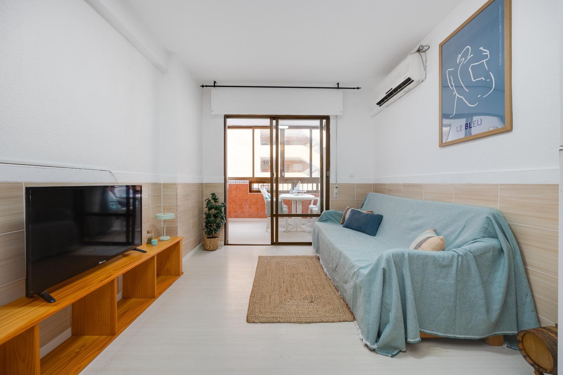 Ощутите атмосферу Средиземноморья в этой светлой квартире в морском стиле, расположенной на второй линии от пляжа, всего в нескольких шагах от моря. Северная ориентация позволяет сохранять прохладу летом, не теряя при этом естественного освещения. Это идеальное сочетание спокойствия и городского комфорта. Квартира включает уютную гостиную-столовую с открытой, полностью оборудованной кухней. Из гостиной есть выход на застеклённую террасу площадью 8 м² с боковым видом на море — идеальное место для отдыха в любое время года. В квартире две спальни (одна двуспальная и одна одноместная) и функциональная ванная комната с душевой кабиной. Важным преимуществом является наличие парковочного места, что обеспечивает максимальное удобство в престижном районе со всеми необходимыми услугами. Это отличная возможность как для выгодной инвестиции, так и для приобретения жилья для отдыха на Коста-Бланка.