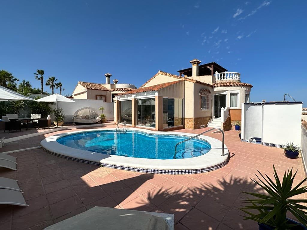 Stylish detached villa in San Miguel de Salinas. This tastefully modernized holiday residence has been redesigned to the highest standards. Built on its own private plot of 423 m2, this Mediterranean style home was built in 2003 in the quiet residential area of Lake View Mansions, just a 5-minute drive from the town of San Miguel de Salinas. 

The south oriented Villa benefits from a bright large lounge area with adjacent dining room. A separate fitted kitchen with utility room and access to the basement level and the solarium. The ground floor level offers 1 double bedroom, with built-in wardrobe and en-suite bathrooms and 1 bedroom with dressing room and separate bathroom. 

The basement level, connected by an interior staircase, offers a fitness area and small office, a separate kitchen/lounge area and 2 double bedrooms with built in wardrobes and both with en-suite facilities. 

The upper level offers a sun terrace with panoramic views and a large solarium with full size Jacuzzi and gazeebo, which enjoys the sea, salt lagoon and mountain views. The front garden with car access being tiled for low maintenance; as well as a proper pool bar lounge etc. perfect areas for your entertaining whilst enjoying the Mediterranean sun. The pool area with shower and plenty of seating facilities create a perfect holiday atmosphere you and your loved one do not want to miss. Ideal rental property of family home under the spanish sun. 

The small urbanization benefits from an excellent bar/restaurant called The Black Bull Steakhouse which is operated by a charming Scottish family and serves great food at very competitive prices in a relaxed atmosphere. The village boasts an array of services and amenities including tapas bars, shops, restaurants, a pharmacy, health centre, banks, bus service, sports facilities, a municipal swimming pool and more. The Villa has 8 Golf courses surrounding it. Las Colinas Golf just 5 mins drive away.