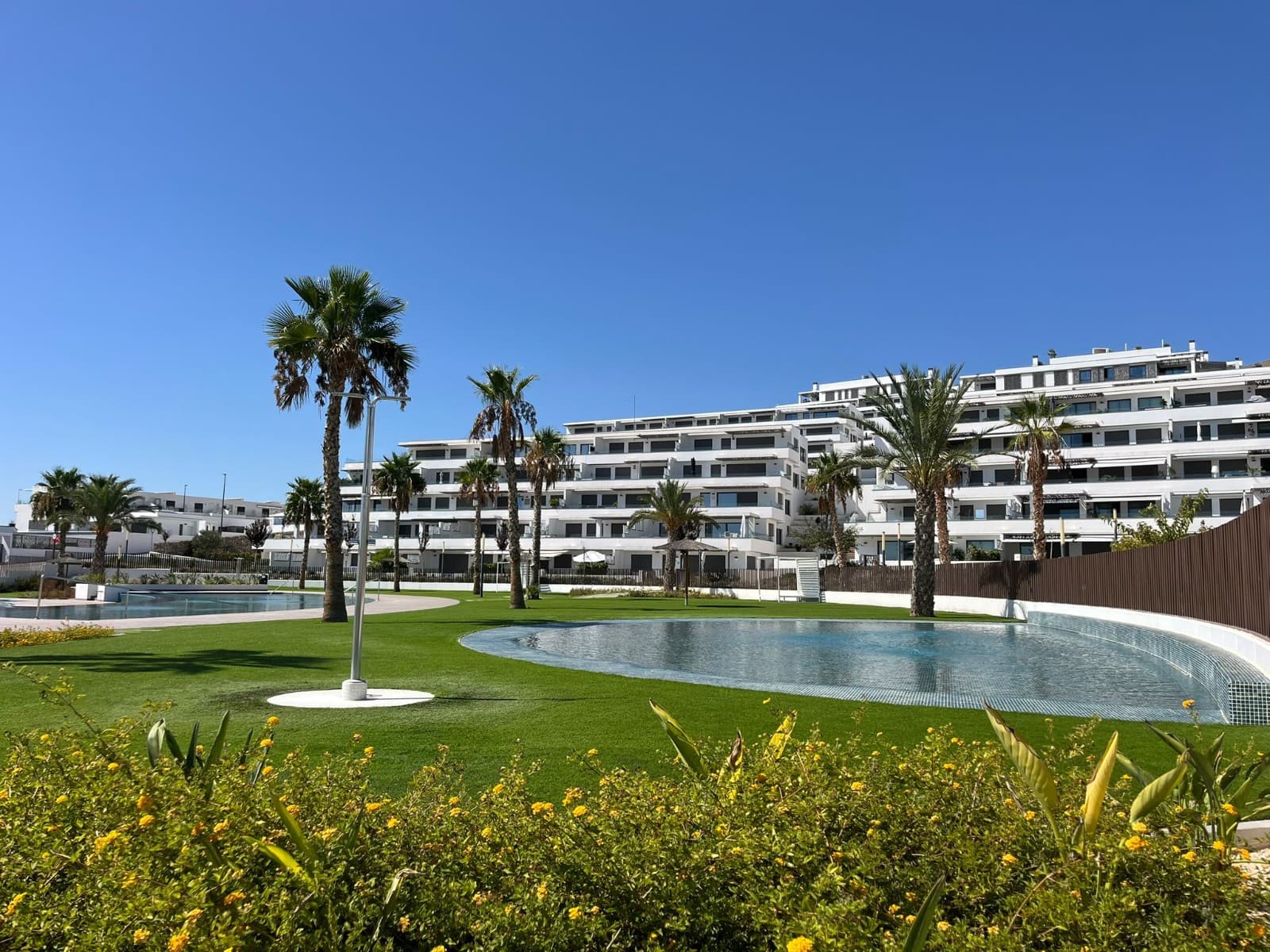 Welcome to your dream apartment in Finestrat! This exquisite residence boasts three spacious bedrooms and two luxurious bathrooms, offering a perfect blend of comfort, style, and breathtaking views. Located in the heart of Finestrat, this high-rise apartment provides you with a unique vantage point to admire the stunning beauty of the vibrant coastal city, Benidorm.

Upon entering the apartment, you are greeted by a warm and inviting living area that features floor-to-ceiling windows, allowing natural light to flood the space and showcase the magnificent vistas of Benidorm. The tastefully designed interior exudes a modern and elegant ambiance, with carefully selected furnishings and a harmonious color scheme.

The open-plan living room seamlessly connects to a well-appointed dining area, perfect for hosting family gatherings or intimate dinners with friends. The fully equipped kitchen, complete with state-of-the-art appliances and ample counter space, ensures that culinary endeavors are a delight. Whether you're savoring a homemade meal or simply enjoying a morning coffee, the panoramic views of Benidorm's picturesque coastline will provide a constant source of inspiration.

Moving into the sleeping quarters, you will discover three generously sized bedrooms, each designed to provide utmost comfort and tranquility. The master bedroom is a true sanctuary, offering a plush king-size bed, ample storage space, and a private en-suite bathroom. Imagine waking up to the sight of the sun casting its golden rays over the glistening waters of the Mediterranean Sea.

The additional two bedrooms, also spacious and tastefully decorated, offer comfortable accommodations for family members or guests. A second bathroom with modern fixtures and finishes caters to the needs of all occupants, ensuring convenience and privacy for all.

As you step out onto the balcony, you are greeted by an awe-inspiring panorama. The sweeping views of Benidorm's skyline, in combination with the azure waters are simply breathtaking. This private outdoor space invites you to relax, unwind, and soak in the enchanting atmosphere day or night, with the shimmering lights of the city creating a captivating spectacle after sundown.

Moreover, the apartment complex itself offers a range of amenities to enhance your lifestyle. You can take a dip in the refreshing communal pool, work out in the state-of-the-art fitness center, or unwind in the lush gardens. Additionally, the apartment comes with private parkingspot, ensuring convenience and peace of mind.

With its prime location, stunning views, and luxurious features, this apartment really is a true gem.