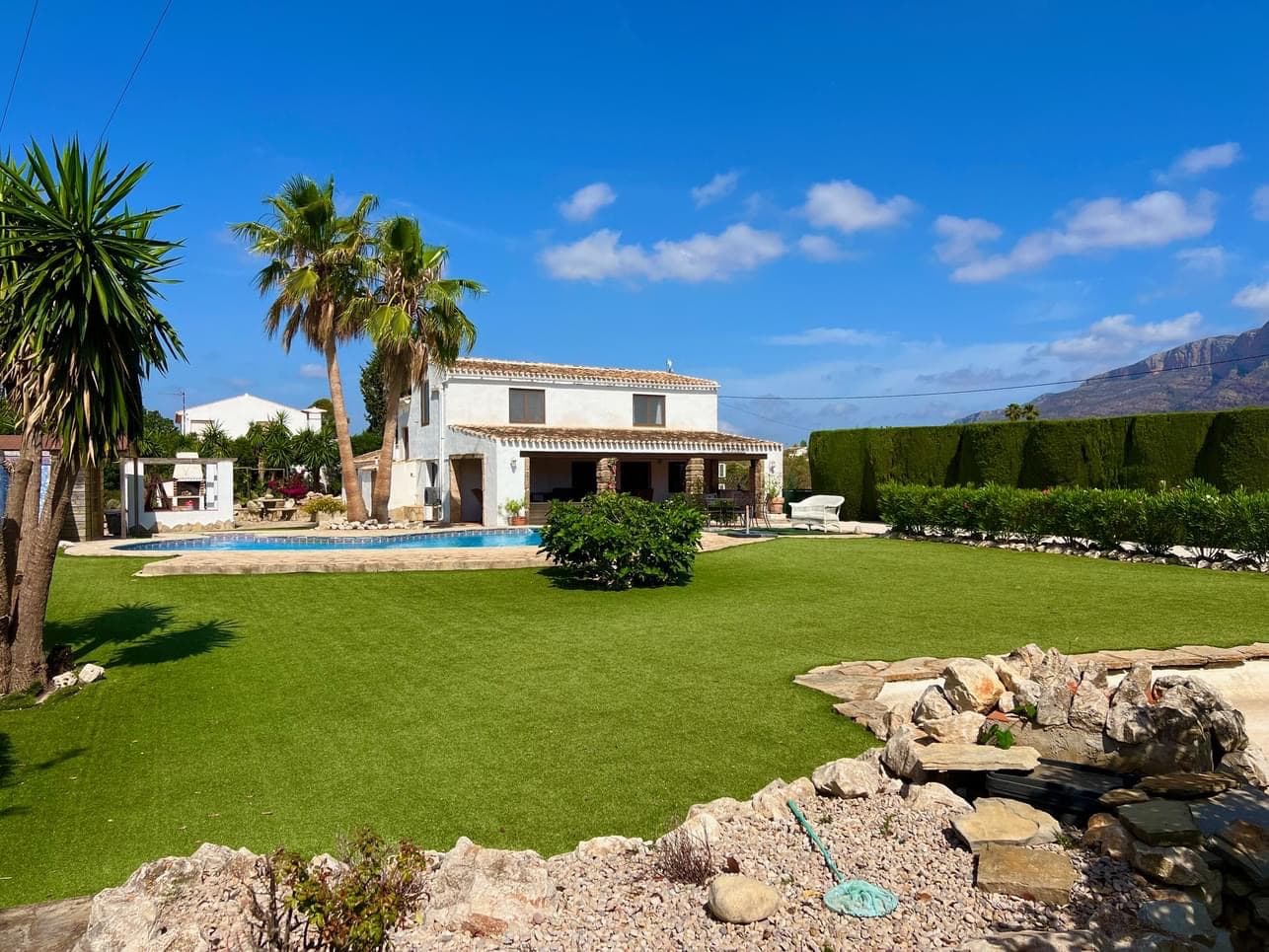 This charming villa, brimming with character dates back over 2 centuries and is ideally located on the outskirts of the historic old town in Javea. It includes delightful nayas, perfect for relaxing in the shade. Set on flat land, the villa offers amazing views of the Montgo and the surrounding valley. It is enhanced by serene patios, sunny garden areas, and a free from swimming pool. At the far end of the garden there is also a small orchard with various fruit trees sitting next to a lovely fish pond with a waterfall.Entry to the house is through the open naya, leading into a spacious living/dining room with a wood burning stove. An archway connects this space to the fully equipped modernised kitchen, a few steps from which lead downstairs to 2 double bedrooms, each of which is en suite and access from here to the rear patio garden. There is a 3rd bedroom and a separate bathroom also located here.The lower level also includes another naya area, transformed into a a relaxation space with glass curtains. This allows the area to be open during the warm weather and used as additional living room when the curtains are closed. There is a guest bathroom with shower here also.On the upper floor one will find 2 further double bedrooms both en suite. A small terrace to take advantage of the stunning views.Unbelievable property at an unbelievable price, get in touch now.